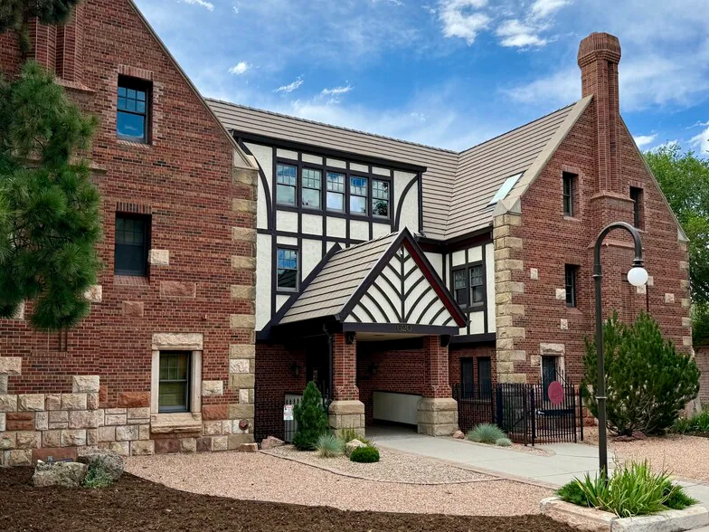 Front of the building for the A Willow Bends Counseling Services location in Colorado Springs. Three story brick building with white and brown wood accents in the middle. Light Xeric landscape and lightpost in front with a walkway to the front door.