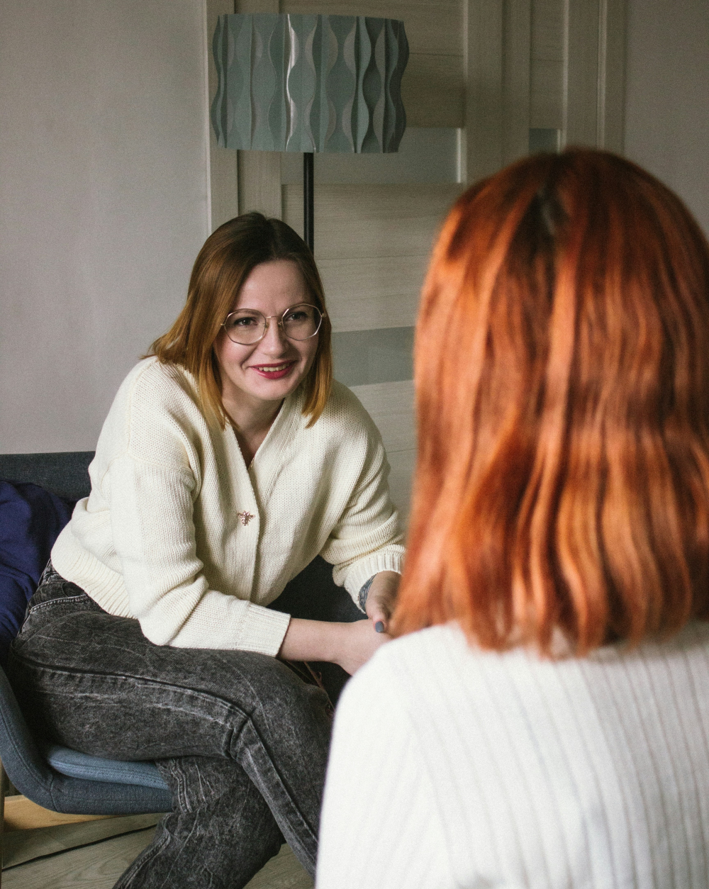 Individual counseling services in Colorado | Image shows a therapist talking with a client.