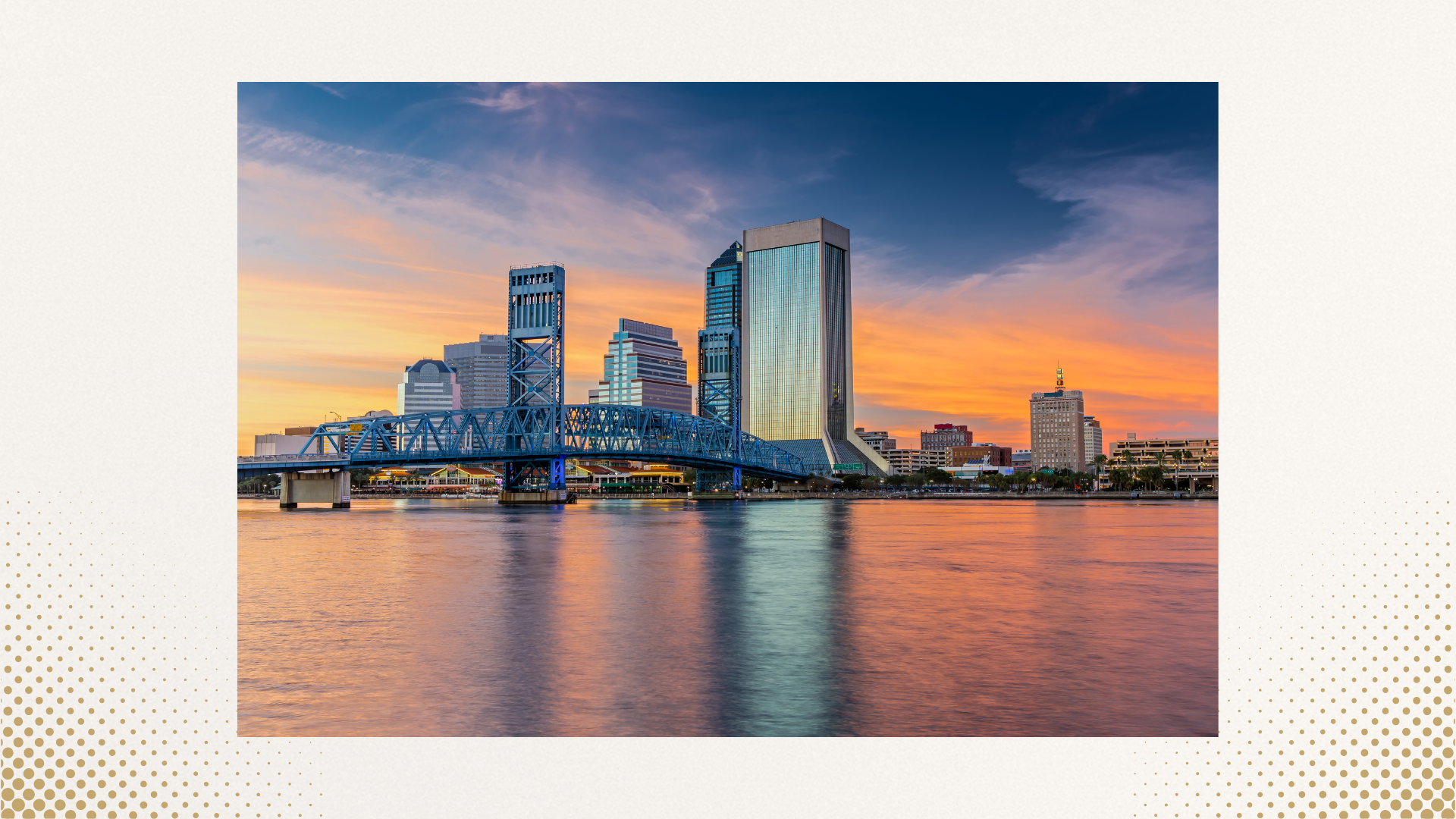 San Francisco skyline at sunset with a blue bridge over water in the foreground.