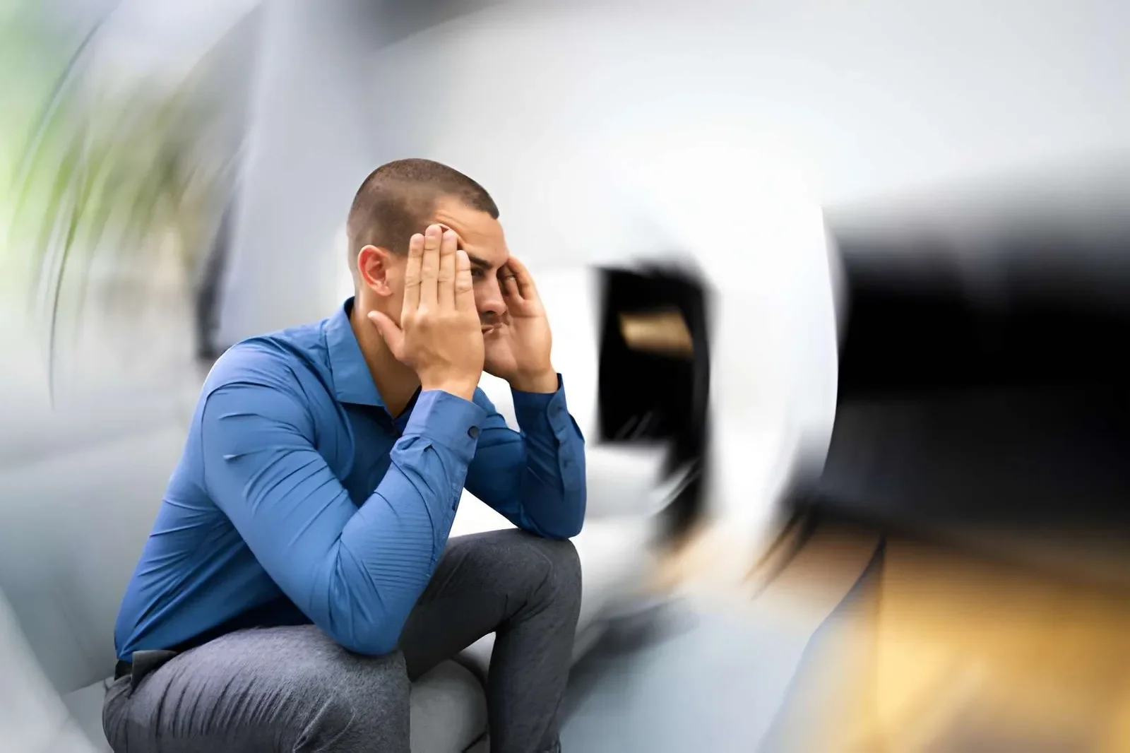 A man sitting, his head spining all over the place