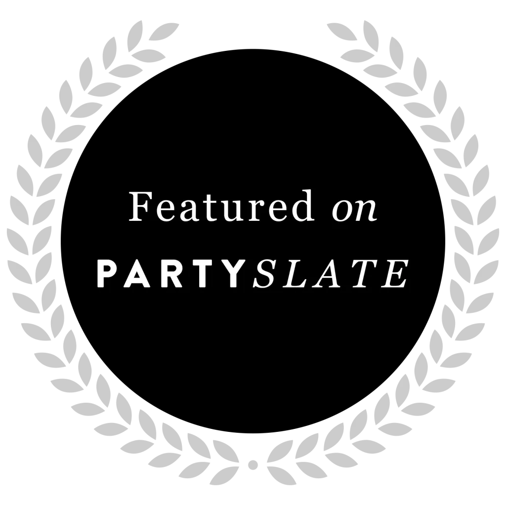 Black circular badge with a gray laurel wreath border, featuring the text 'Featured on PARTYSLADE' in white.