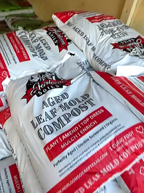 Bags of bird seed labeled 'Aged Leaf Mold Compost'