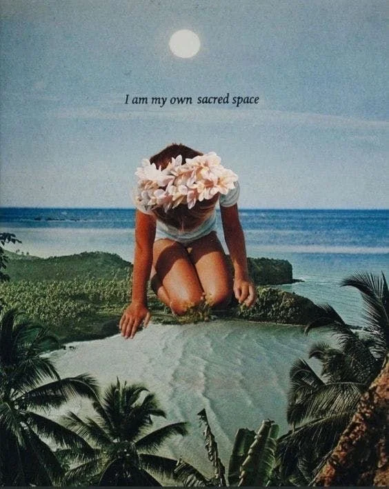 A person kneeling on a beach with their head bowed and a flower crown on their head, surrounded by palm trees, with the ocean and a full moon in the background. The text 'I am my own sacred space' is written above.