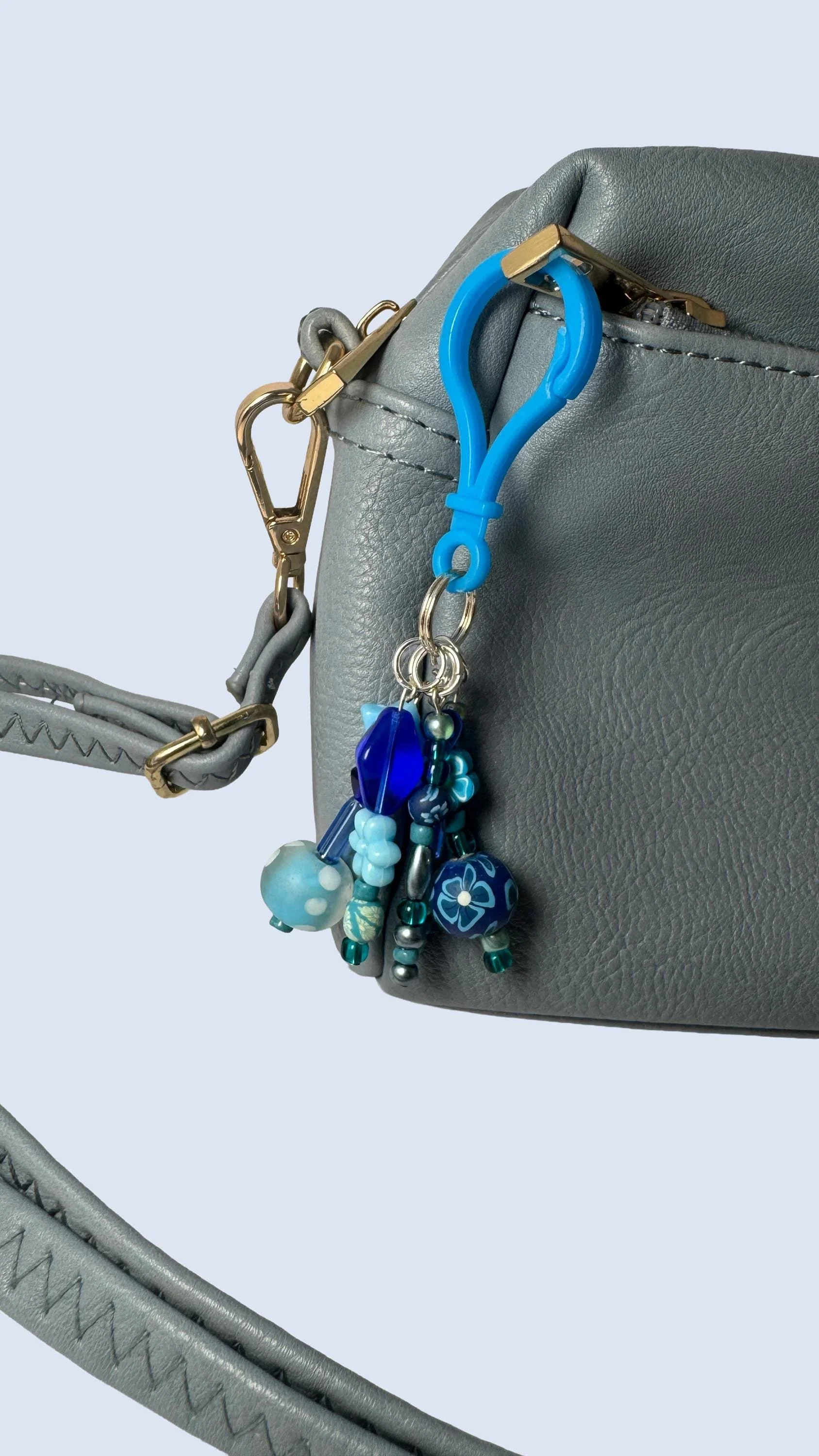 Blue charm on grey purse