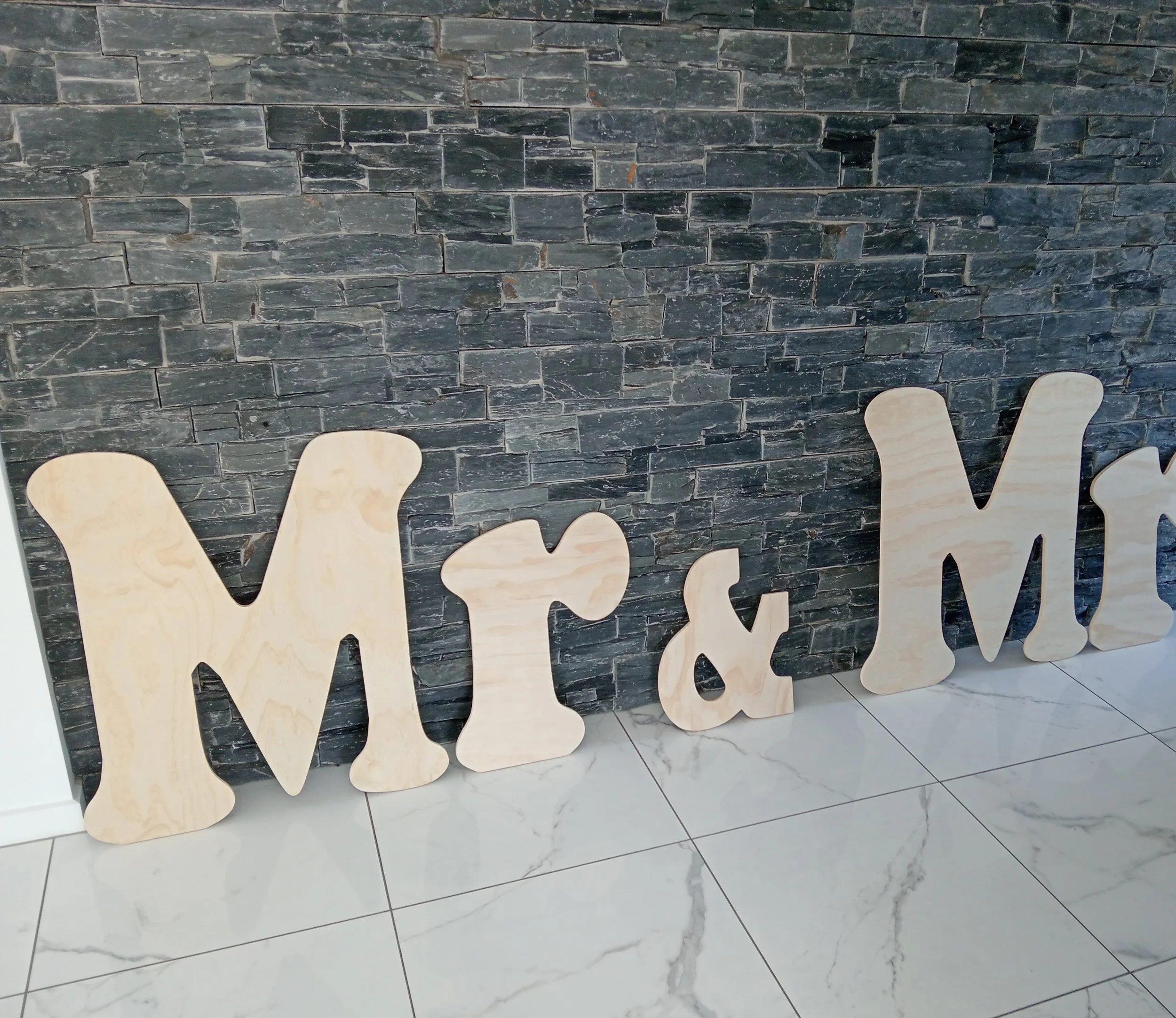 CNC router cutting plywood sheet for signage in New Zealand.