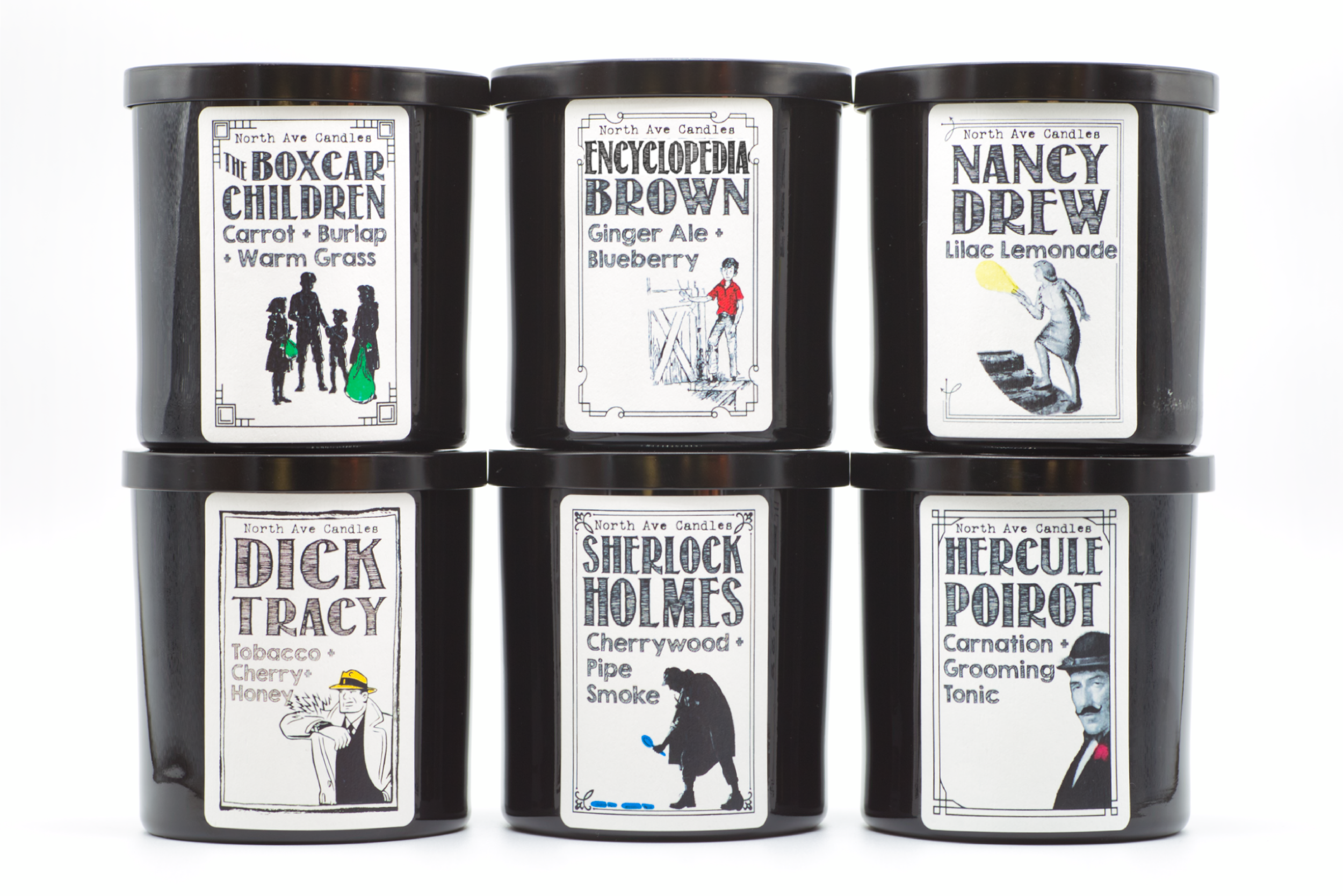 Six black candle jars with vintage style labels featuring names and illustrations, arranged in two rows of three. The labels depict characters from Sherlock Holmes stories, with the top row showing "The Boxcar Children," "Encyclopedia Brown," and "Na