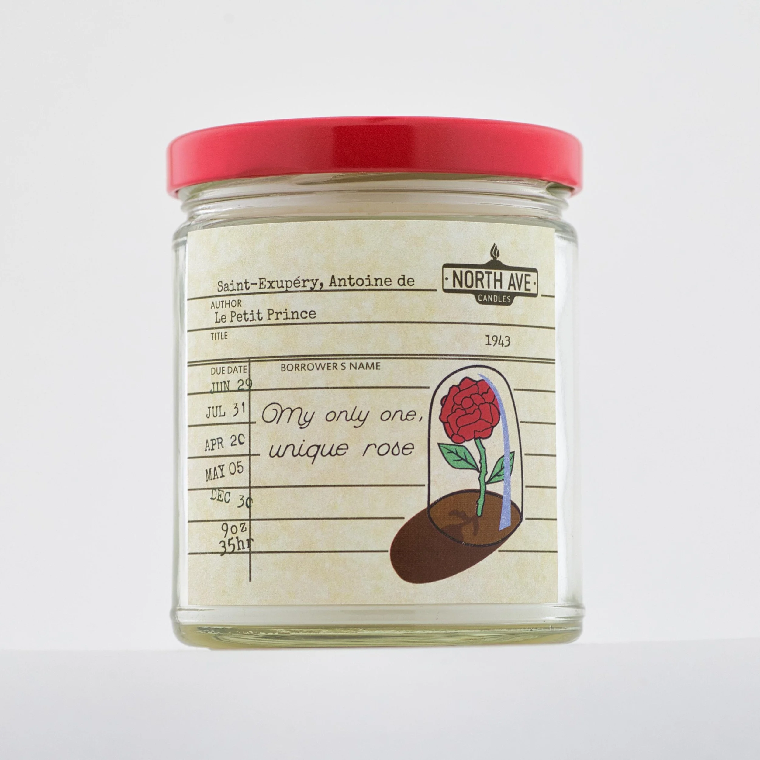 A glass jar with a red lid, label, and a drawing of a rose in soil, with handwritten text and stamped date on the label.