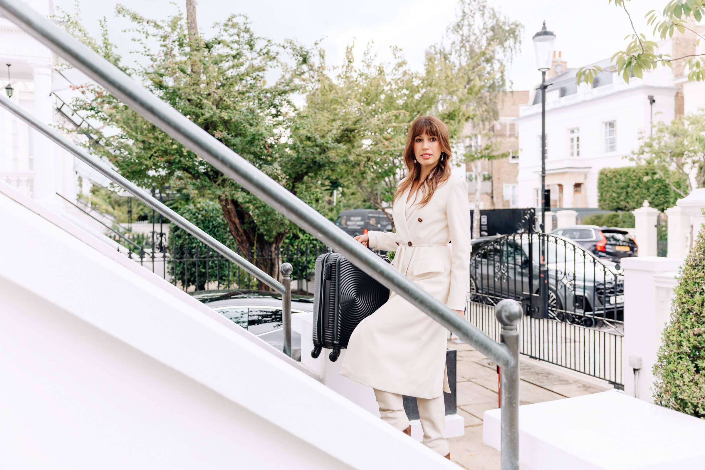 Daniela Nikolova entering a luxury home with her suitcase, arriving for a private facial, body treatment and spray tan appointment.