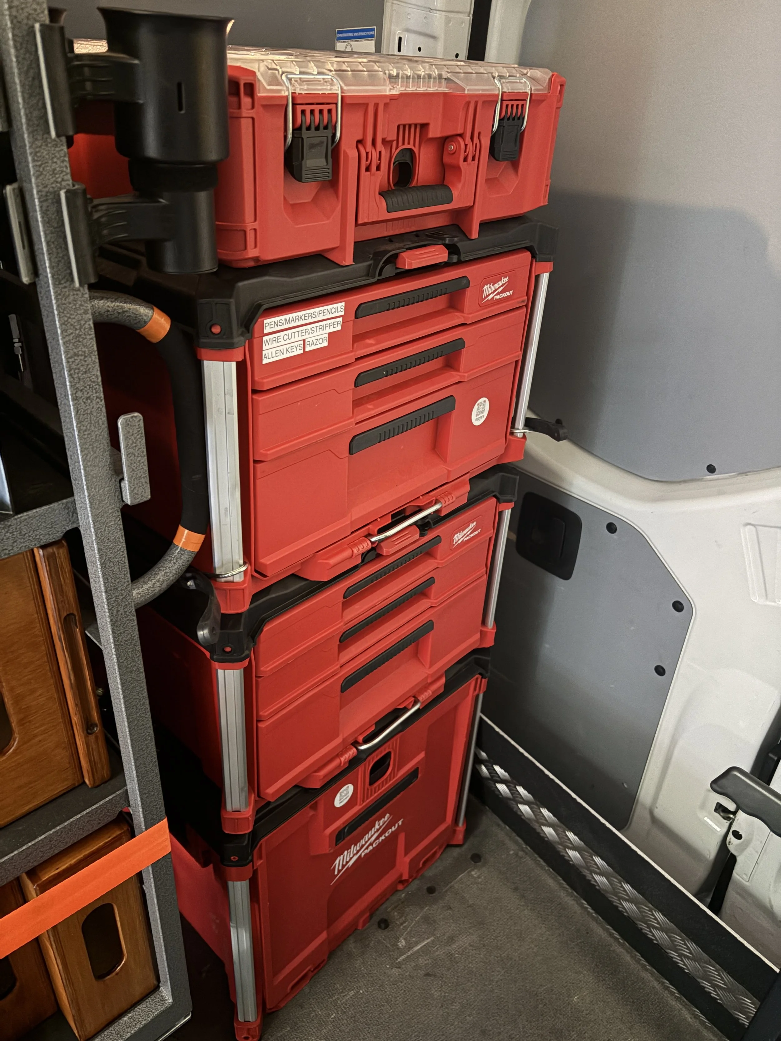 A red Milwaukee Packout toolbox with tools for an Indianapolis 1 ton grip truck