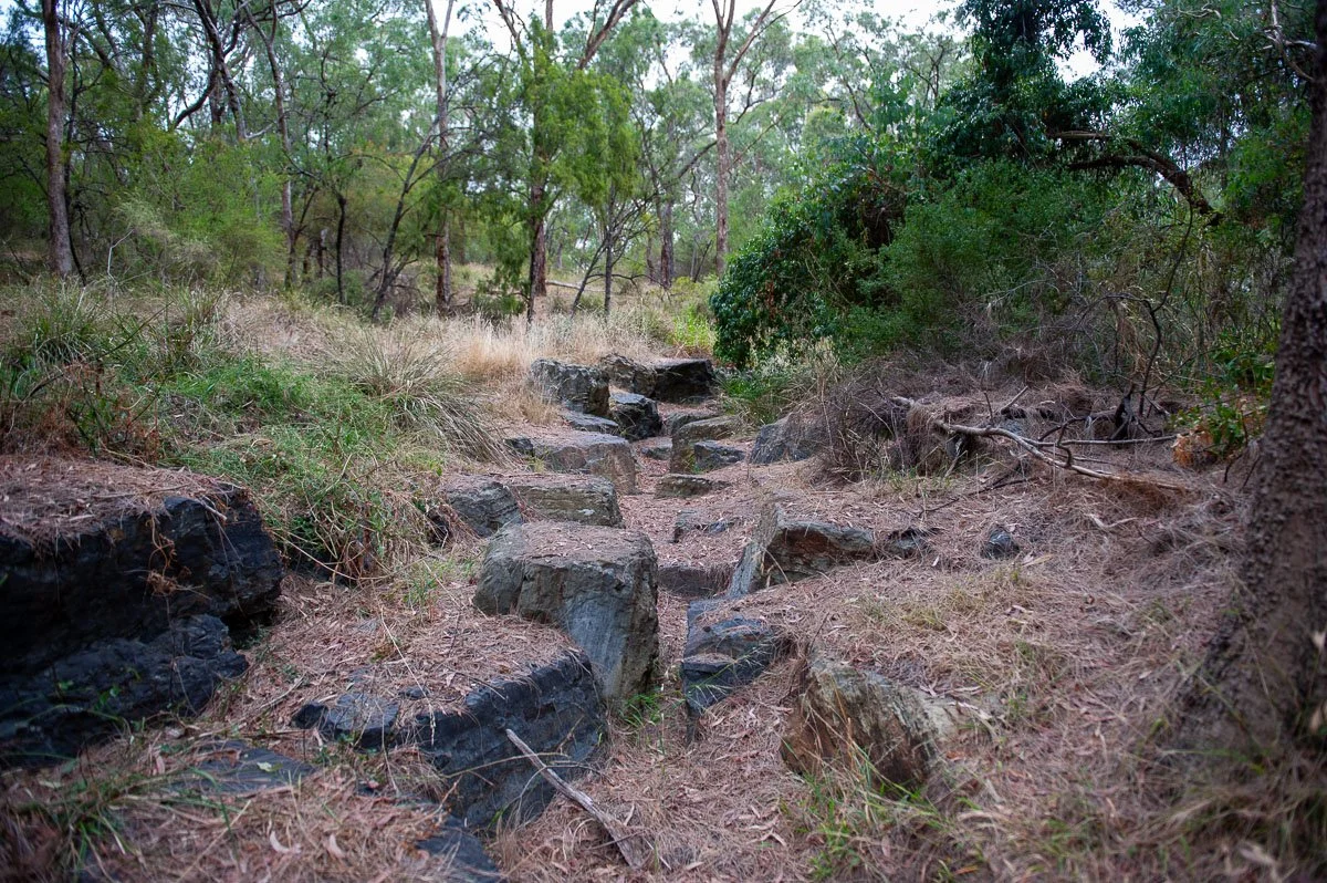 The dry creek bed at Yarran Dheran, showing exposed rocks and parched ground