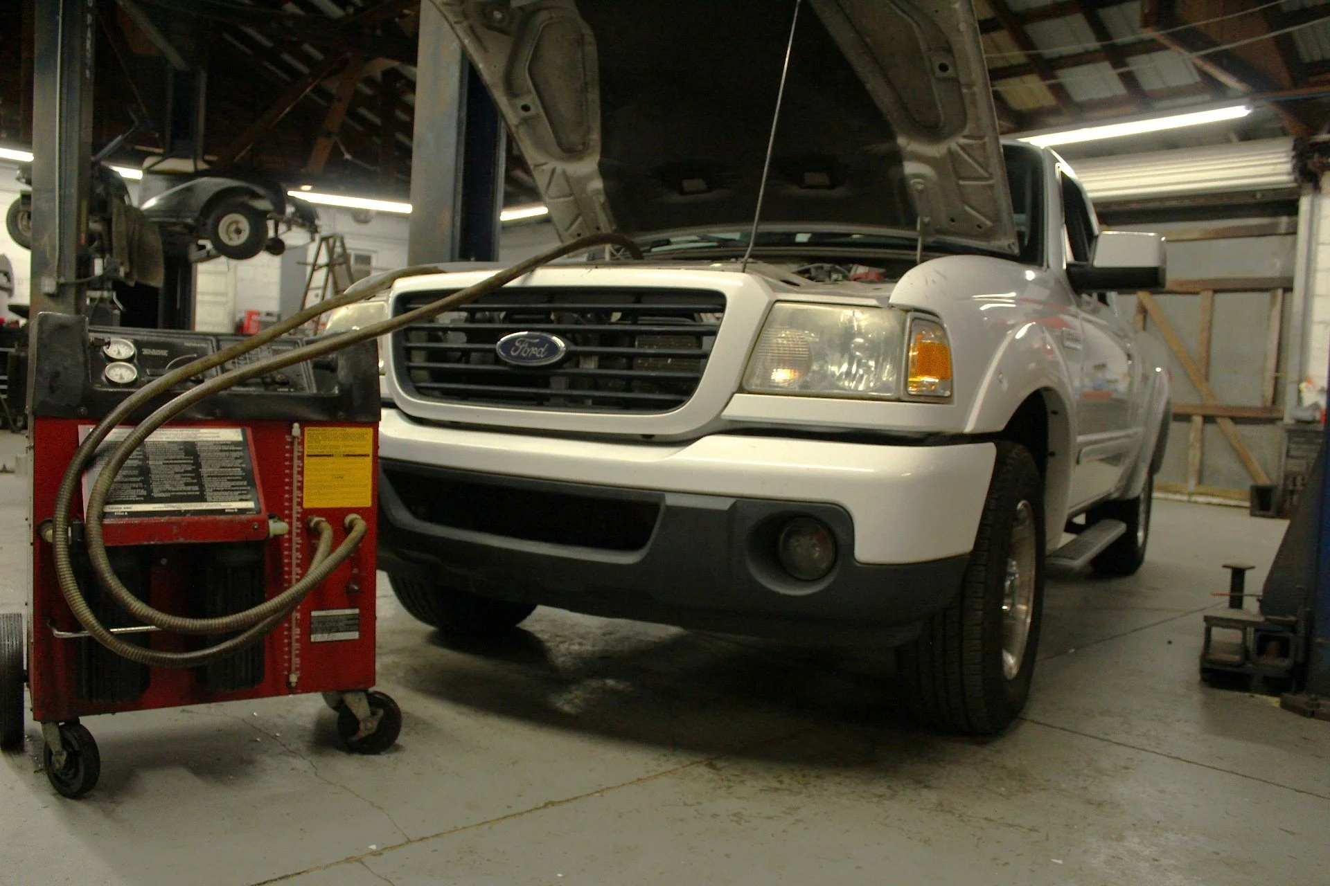 Fluid exchange service being performed on an automobile by a professional technician.