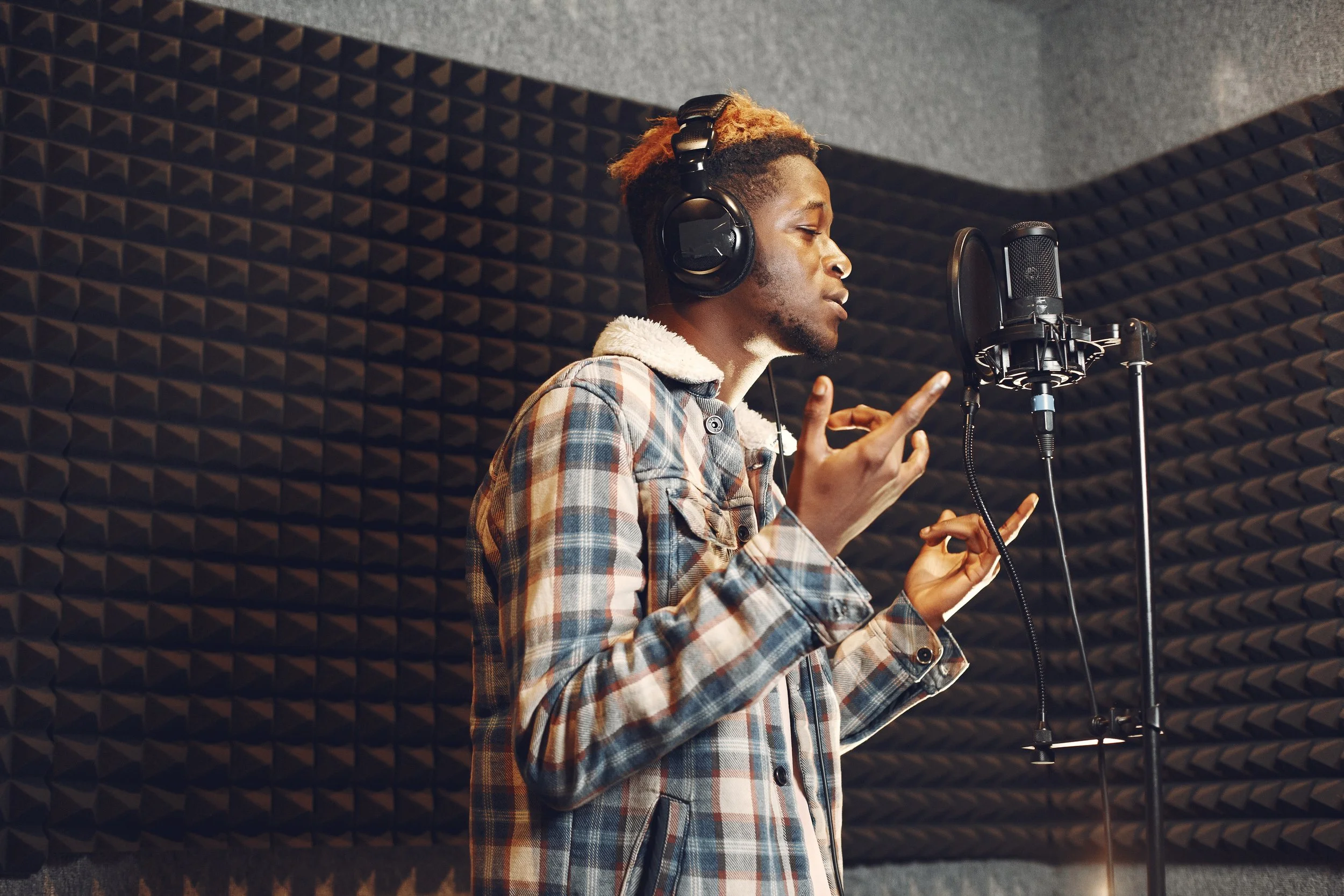 radio-host-gesturing-while-recording-podcast-radio-studio-african-man-rehearses-recording-studio.jpg