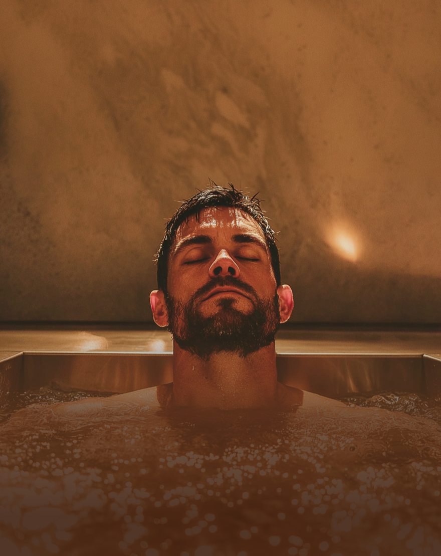 Man submerged in cold plunge tub, benefiting from cold plunge and contrast therapy