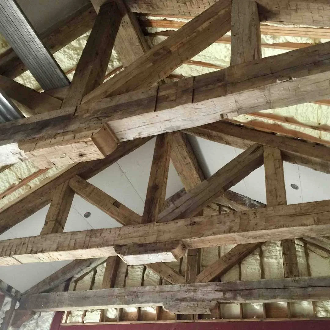 Thumbnail of client installation with antique reclaimed hand-hewn timber frame trusses, showing exposed tool marks and rustic character in vaulted ceiling construction.