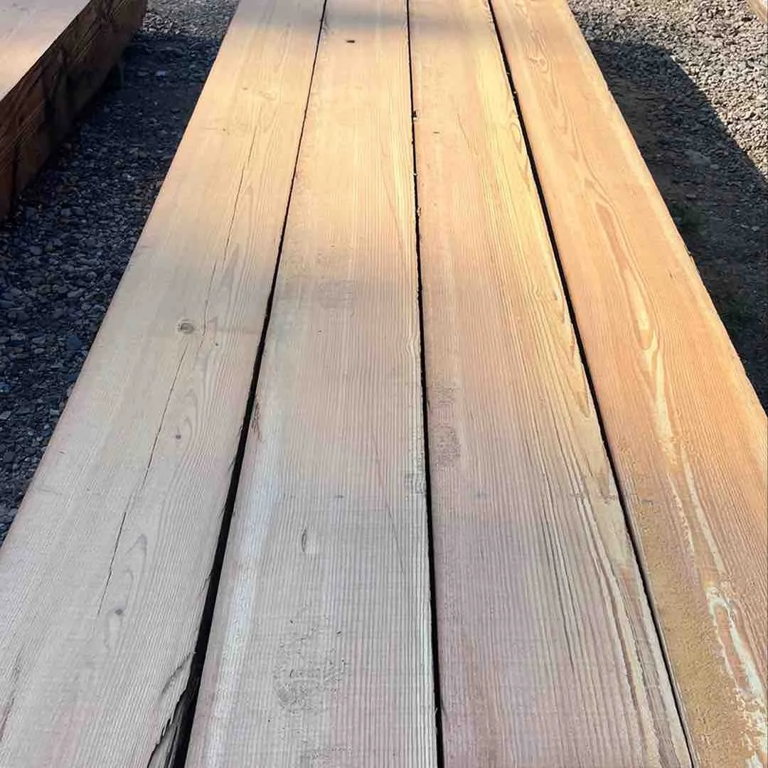 Thumbnail of milled antique reclaimed industrial timbers, showing smooth surfaced planks with visible old-growth grain lines and warm natural patina.