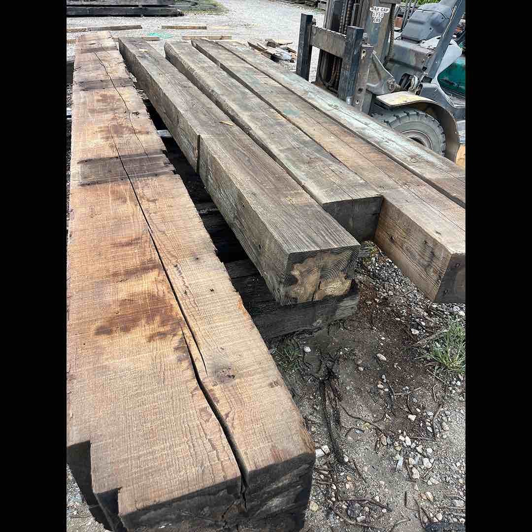 Thumbnail of antique reclaimed industrial timbers stacked on a forklift, showing aged patina, saw marks, and weathered grain.