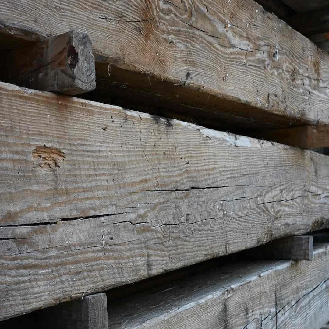 Thumbnail of close-up antique reclaimed industrial timbers stacked with visible grain, aged cracks, and natural patina.