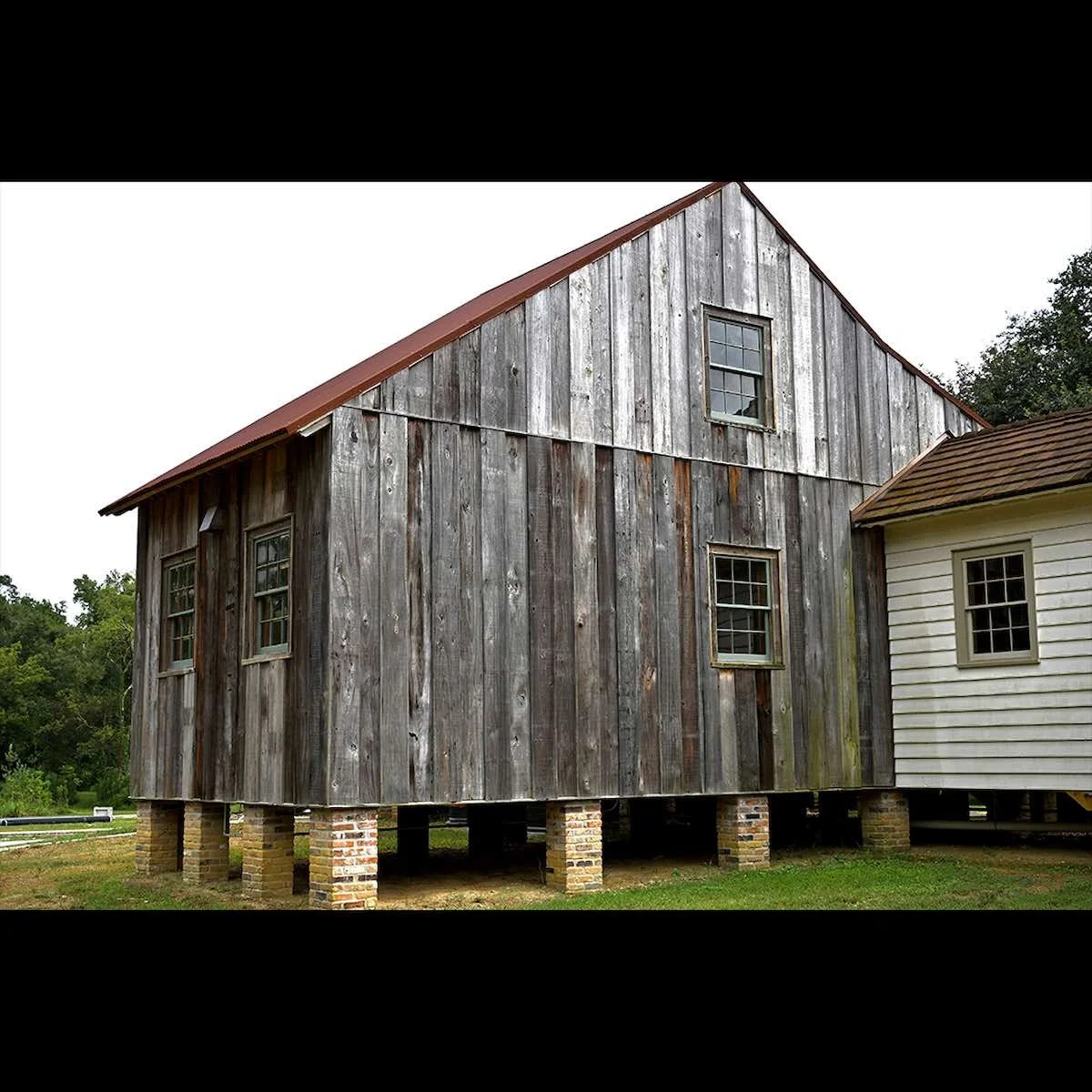 Antique reclaimed grey weathered cypress exterior siding on a client installation, showcasing aged patina, natural texture, and rustic character.