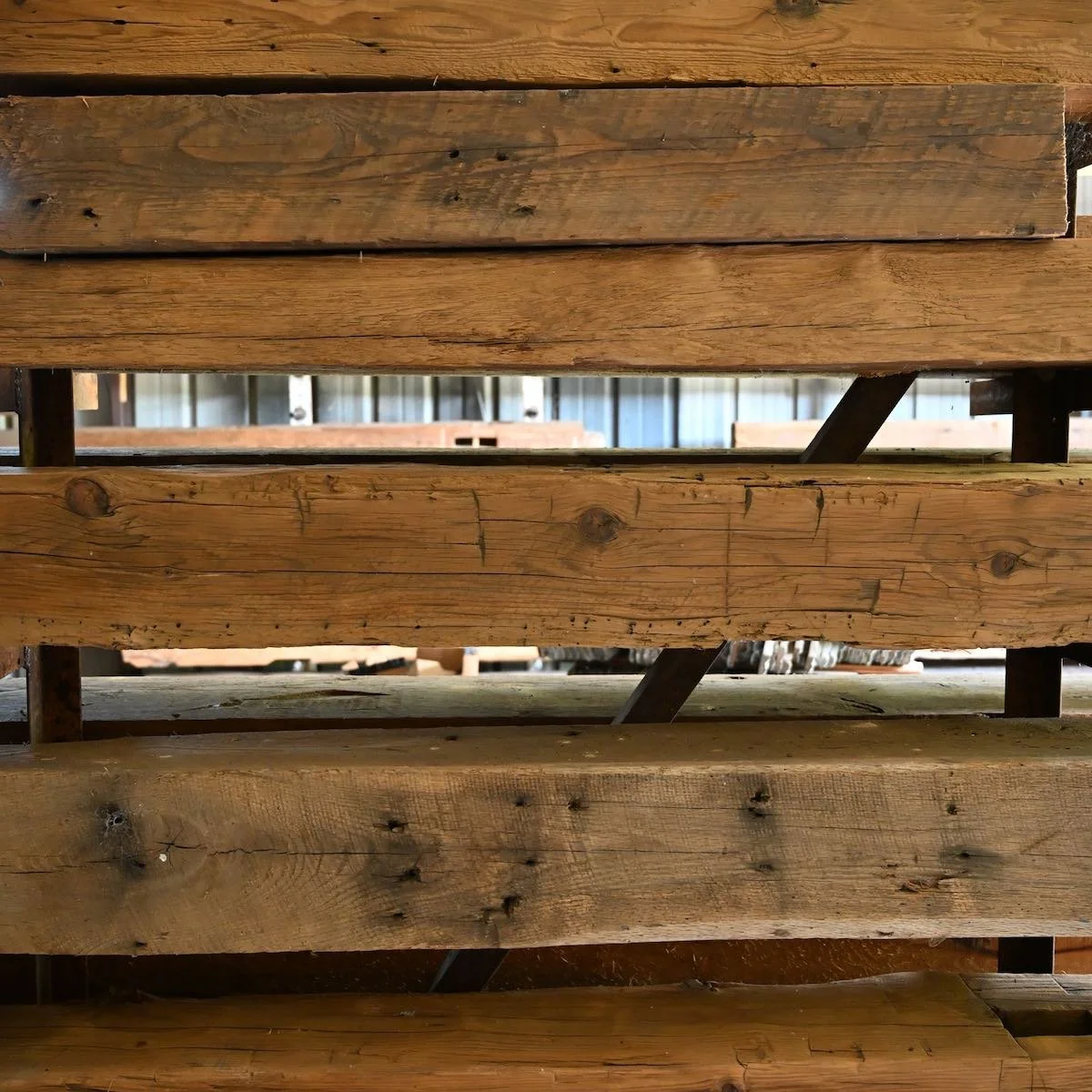 Antique reclaimed beam mantels  featuring nail holes, tool marks, and natural patina.