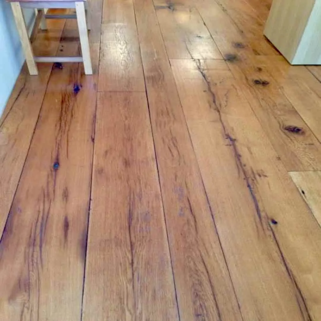 Antique reclaimed white oak finished flooring in a client's home, showcasing natural knots, aged character, and warm patina.