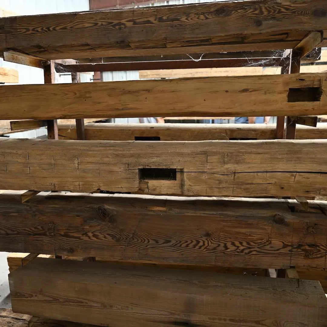 Thumbnail of stacked antique reclaimed beam mantels showcasing visible grain lines, mortise pockets, and natural patina.