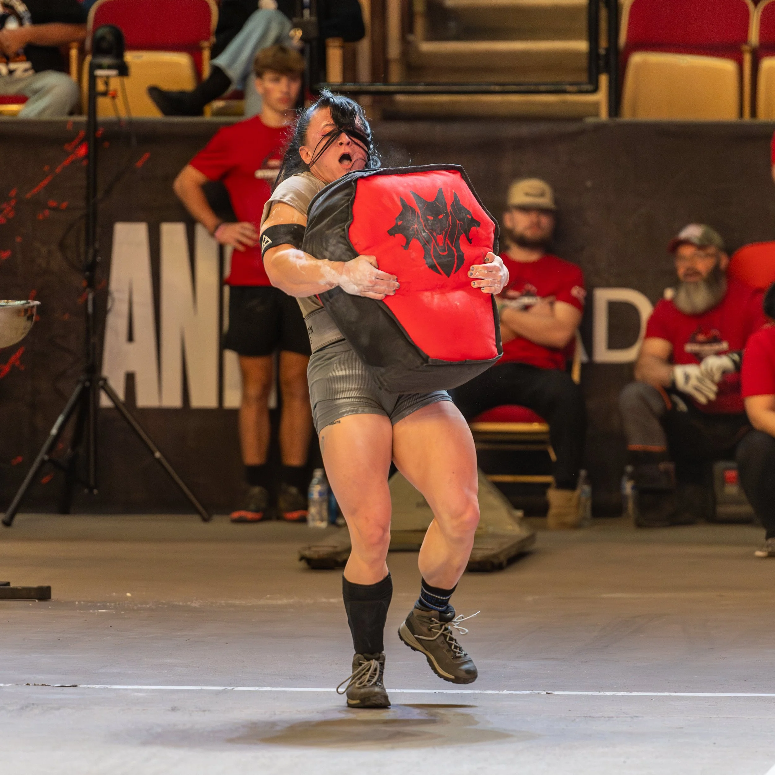 USMC veteran Nancy Johnson competes in the sandbag carry and sled drag event at the Official Strongman Games, a strongman competition. OSG. Veteran strongman athlete. Photo by John Krzesinski.