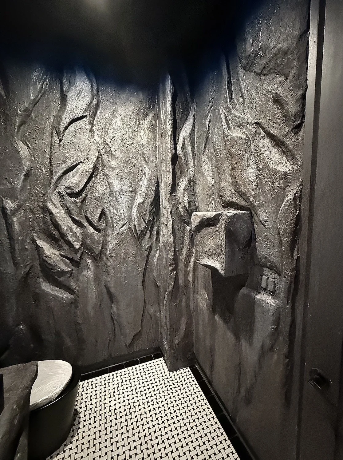 Custom sculpted stone bathrooms by Reimagining Spaces Studio for Nourish in the Bronx, featuring handcrafted organic textures inspired by Tulum luxury design.