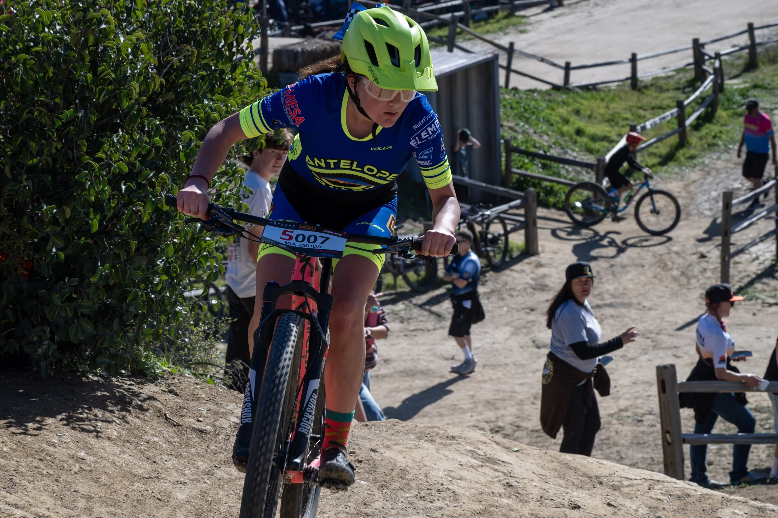 Girl racing a bike up a hill
