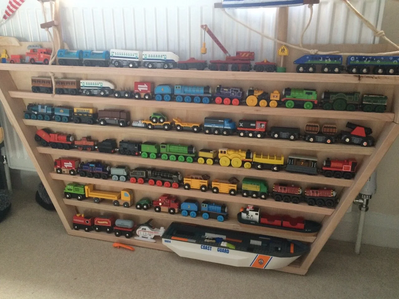 Wooden train set storage in ship shape