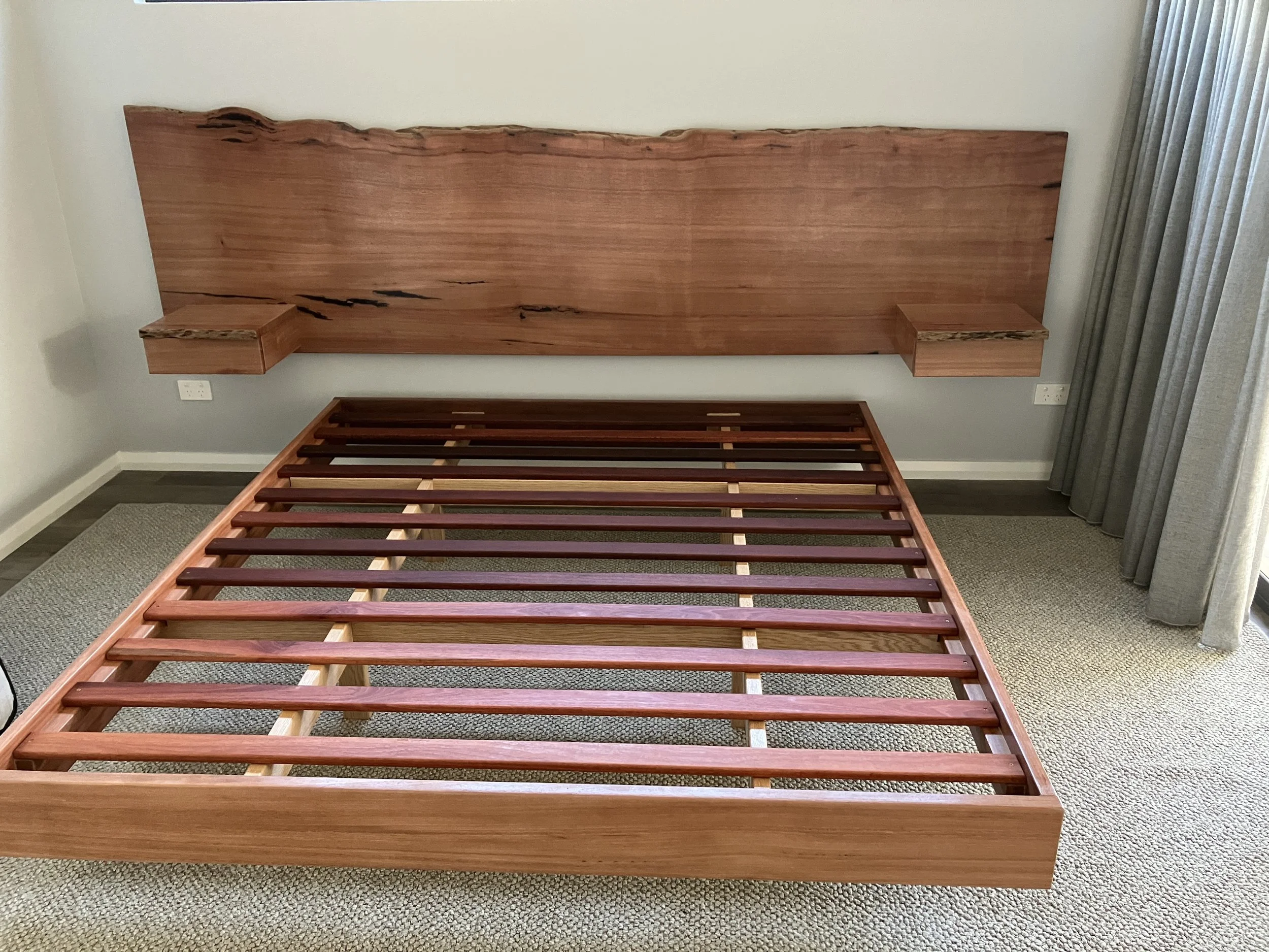 Queens size floating bed with natural edge headboard and drawers wall mounted
JPG
