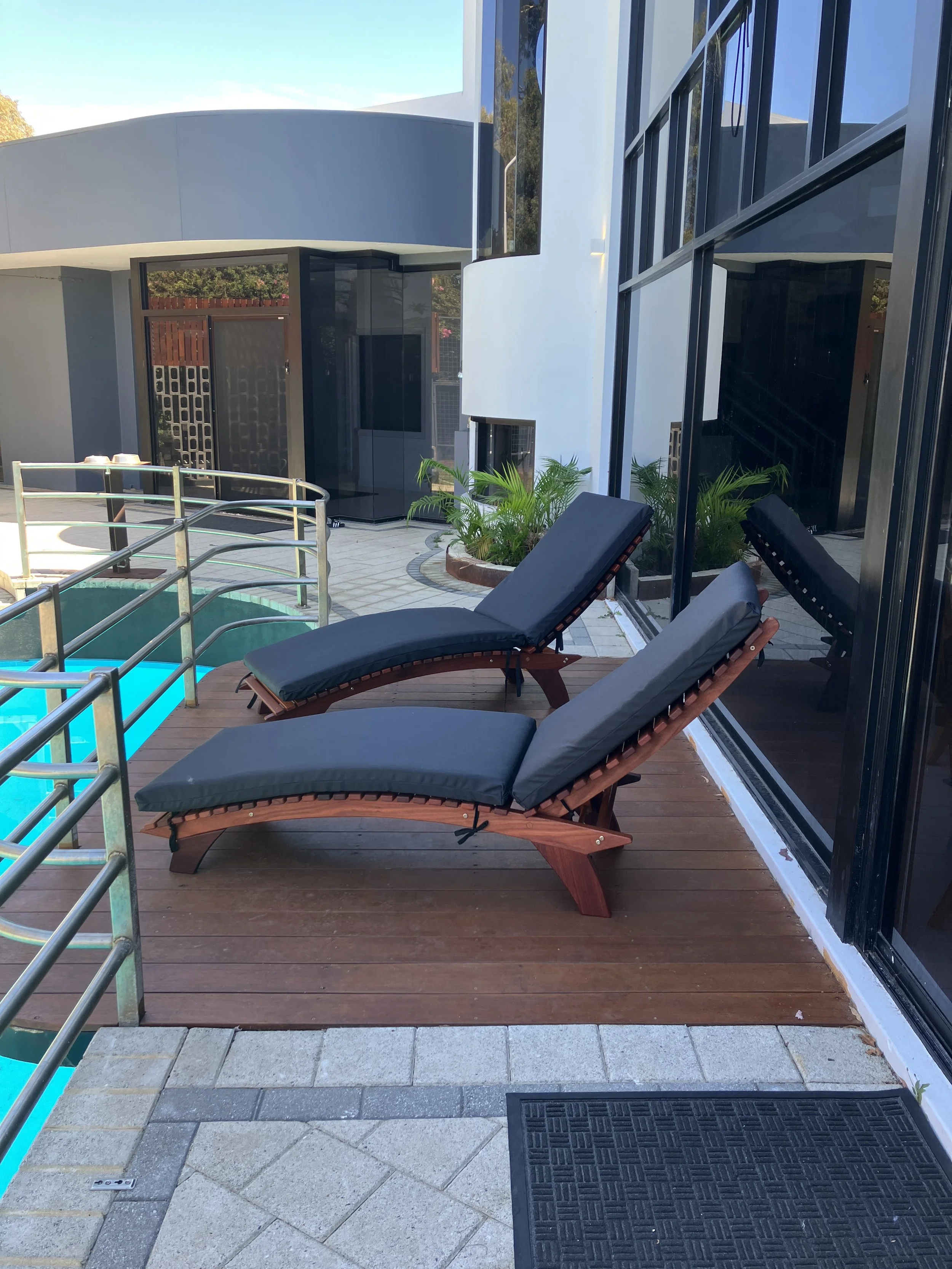 Curved sunlounger with dark Grey Recacril cushions