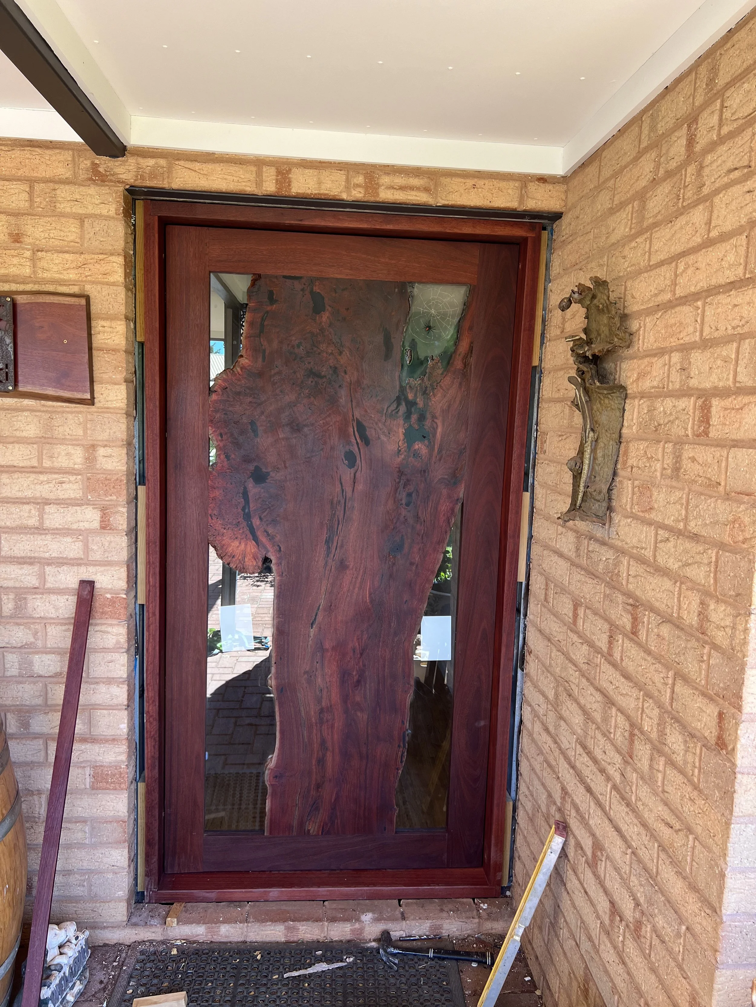 Jarrah spider door and door frames being installed in a home in norther WA