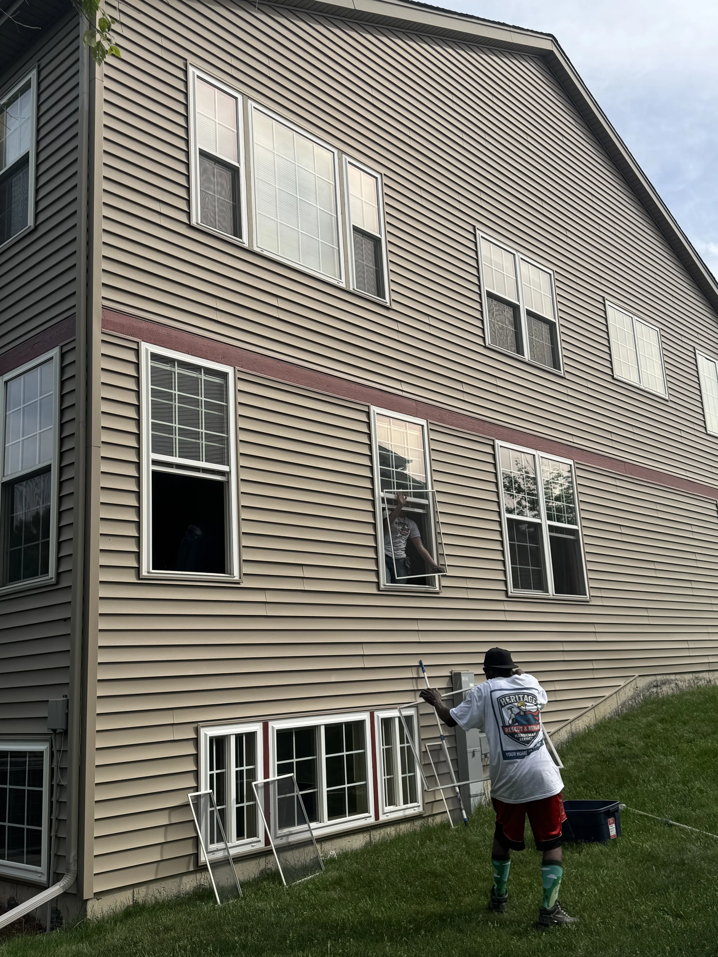 Multi-story window cleaning service reaching hard-to-access 2nd and 3rd story exterior windows.
