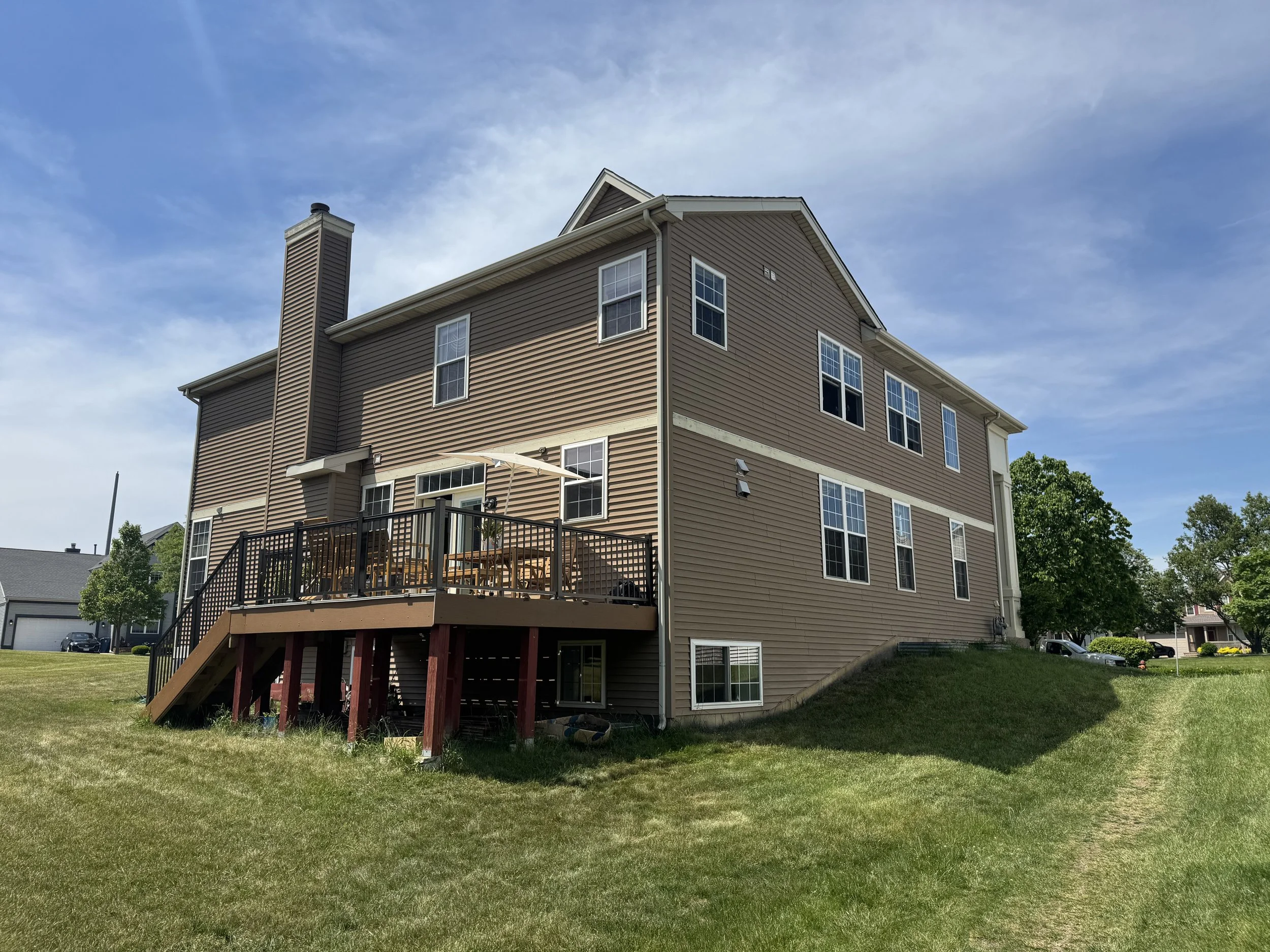 Exterior view of a beautiful Naperville, IL home with sparkling, streak-free clean windows after a professional wash.