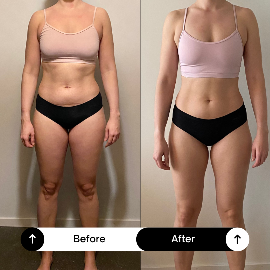 A woman running in a marathon, smiling and making a peace sign with her right hand, wearing a light blue visor and sportswear, with other runners behind her on a street.