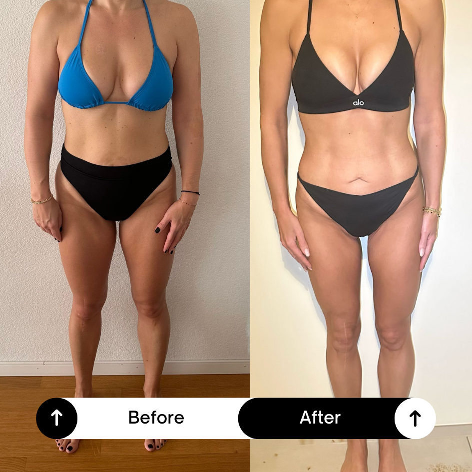 A woman running in a marathon, wearing sunglasses, a pink and purple athletic outfit, and a bib number 2227, on a paved path by a river with historic buildings and a bridge in the background, and an orange traffic cone nearby.