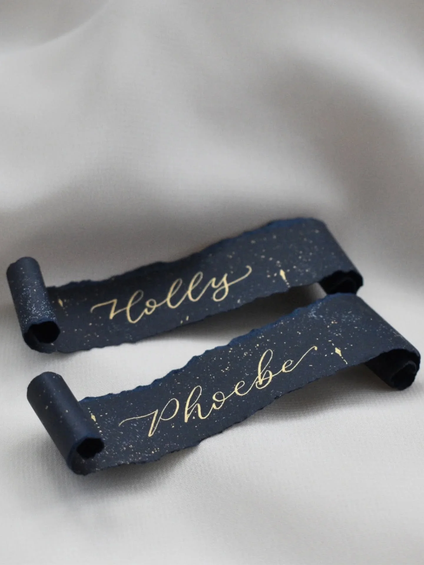 My celestial place card scrolls are now live on my website. ✨

Each one is unique as I dust and sprinkle on the starry background, handwrite them in my dreamy calligraphy style and then carefully roll them into little scrolls. They really are a joy t
