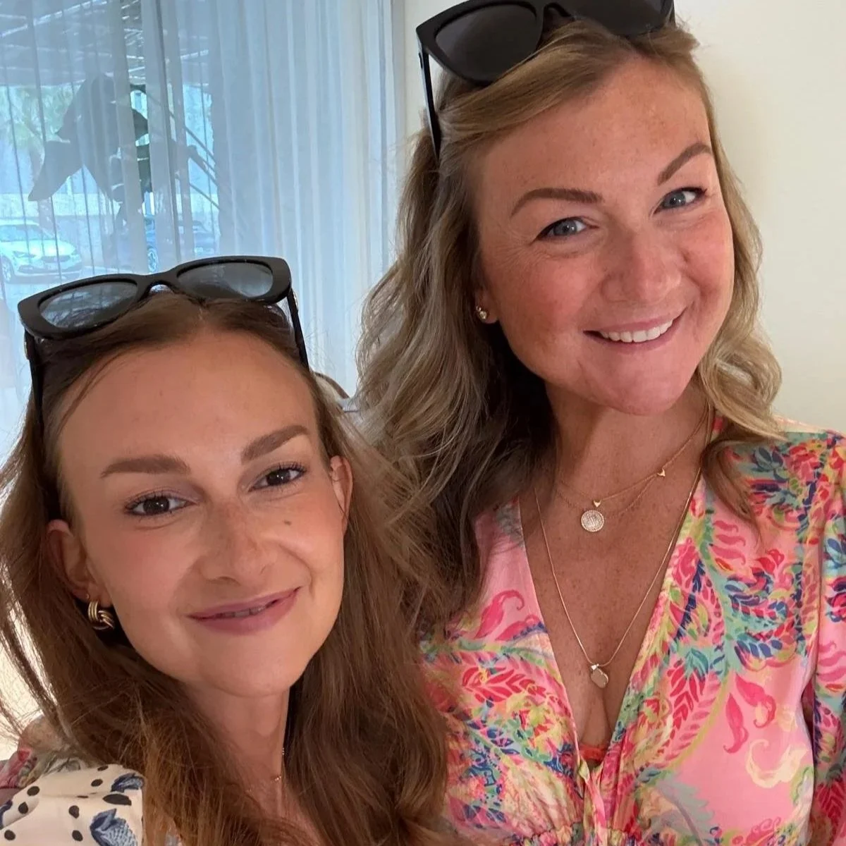 Young woman with long dark hair smiling outdoors
