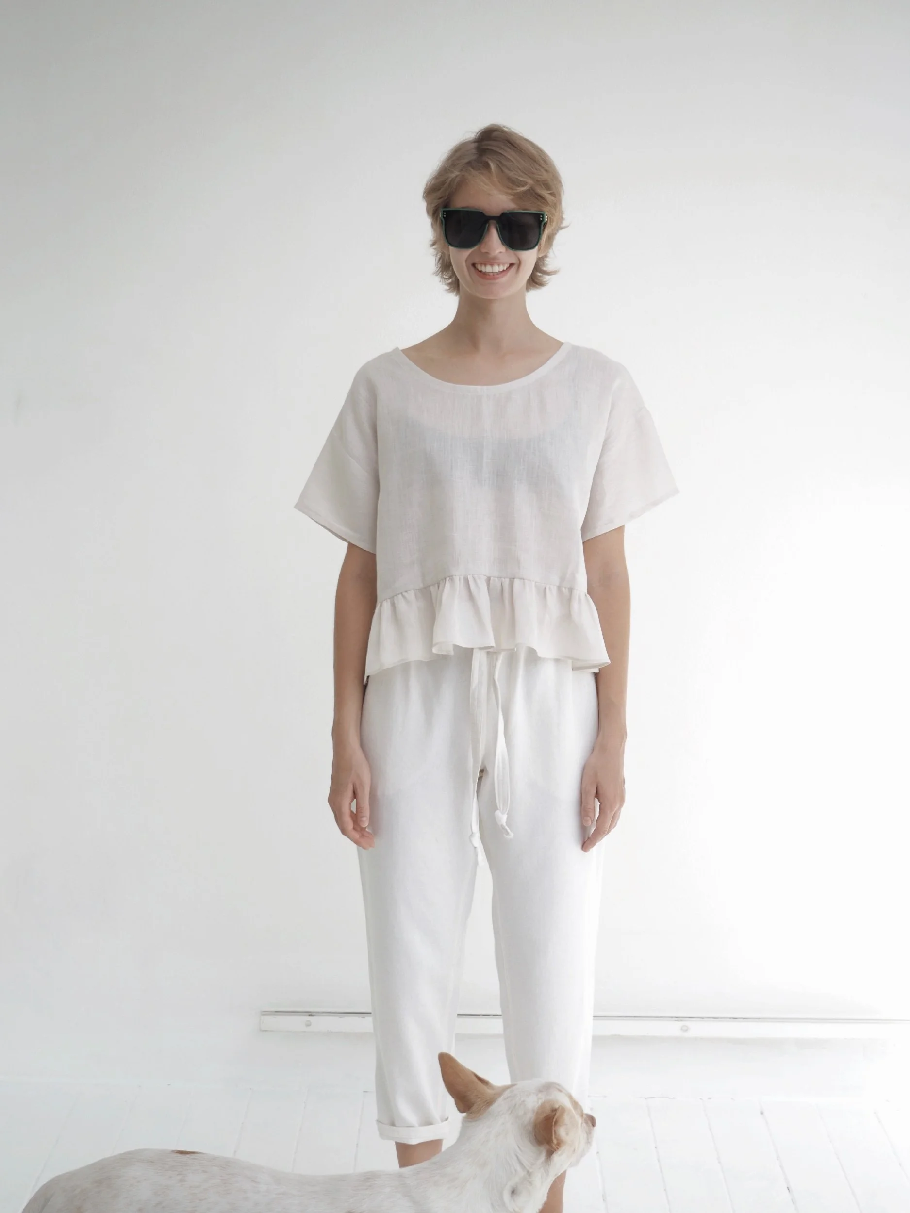 model wearing waist crop lazy top with gathered ruffle extension and short sleeves