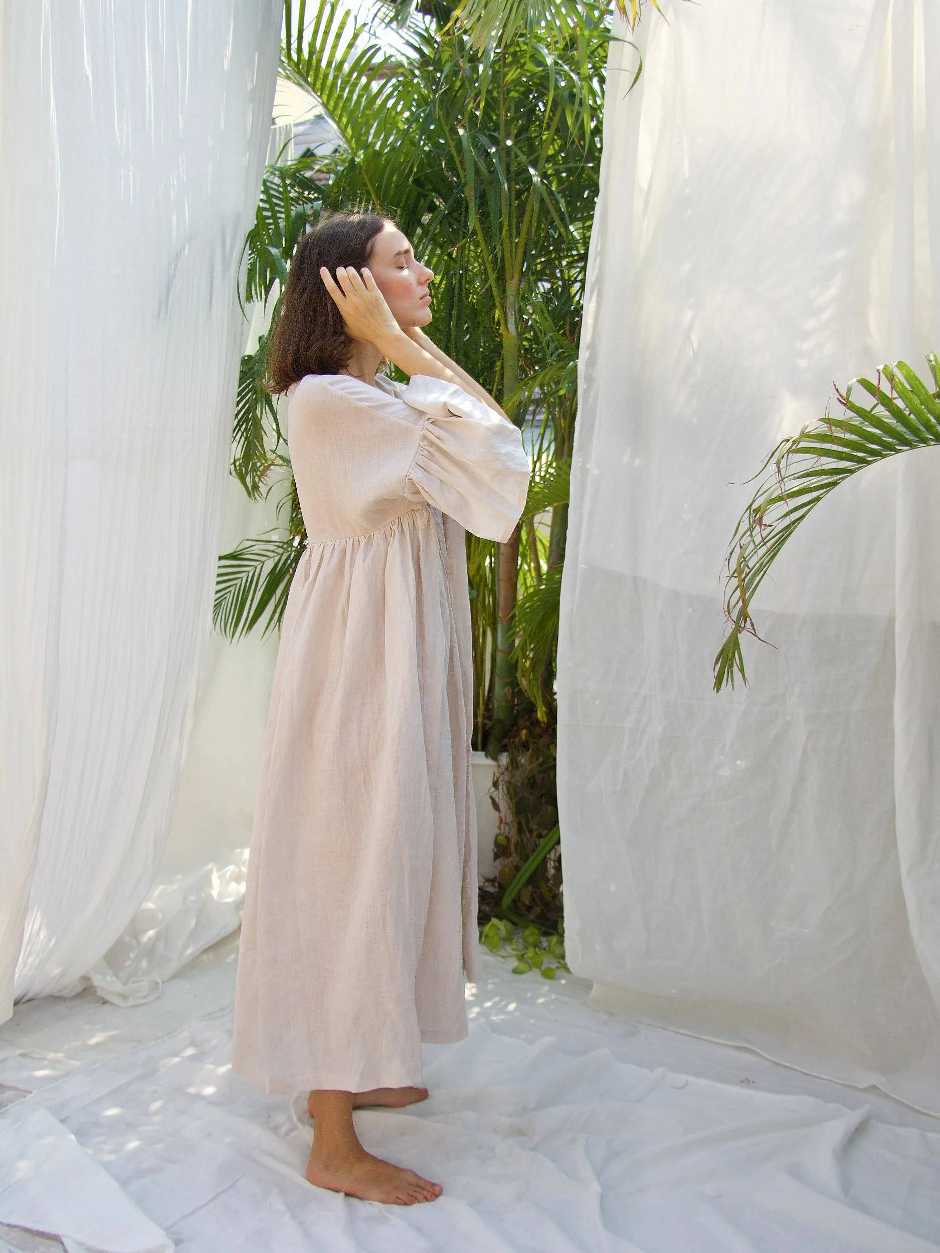 side view model wearing soft pink linen aria dress