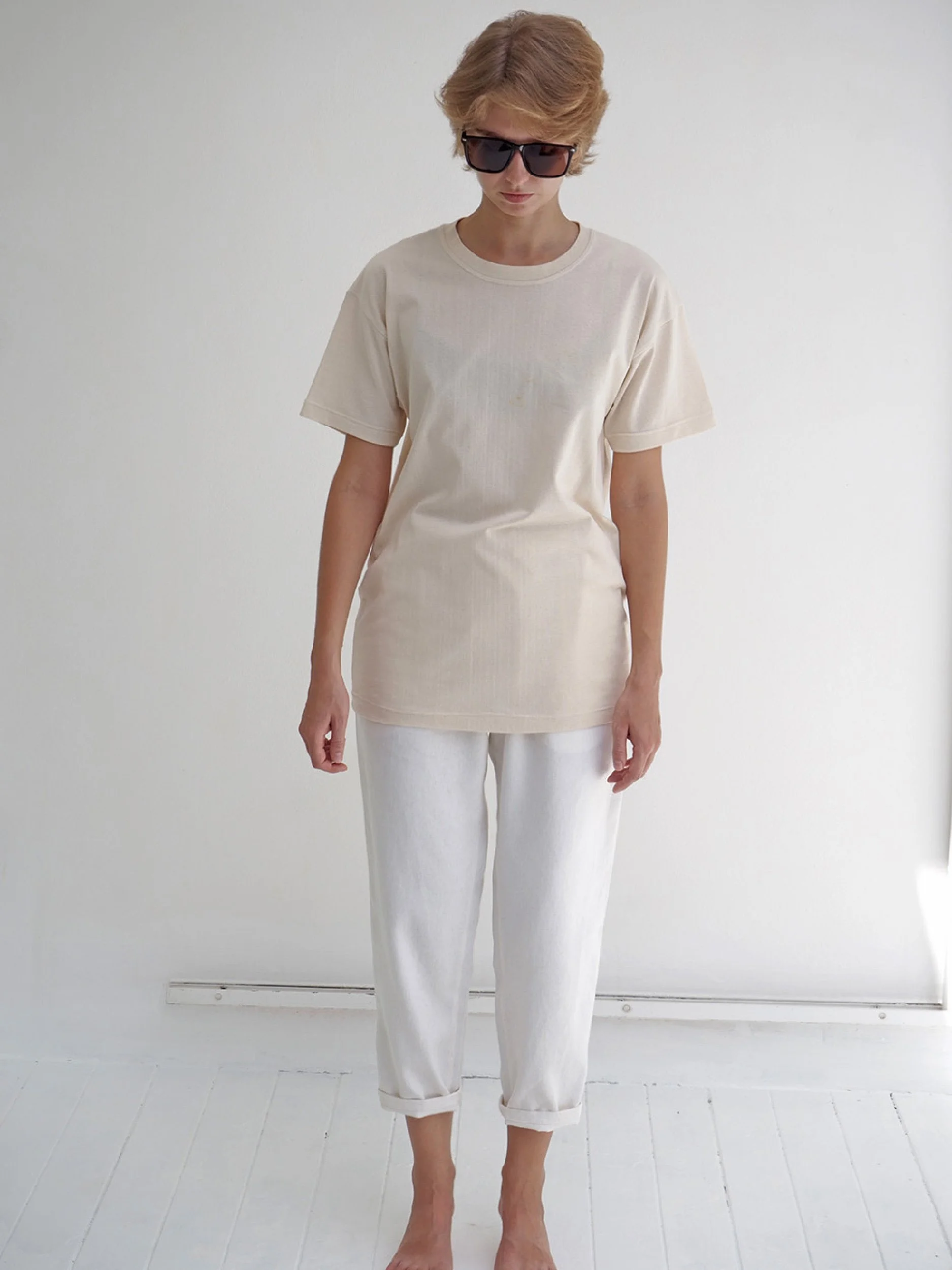 model wearing beige minimalist t-shirt with short sleeves