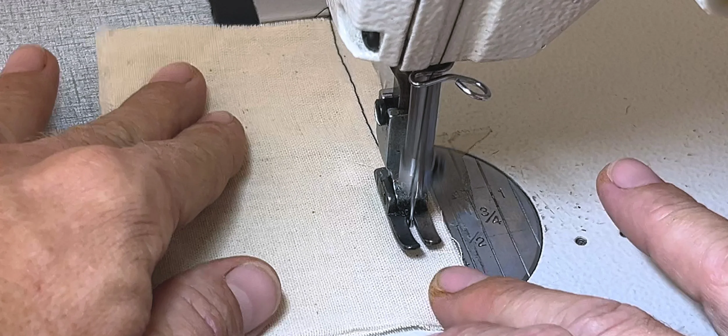 sewing a line of stitches with a sewing machine - close up