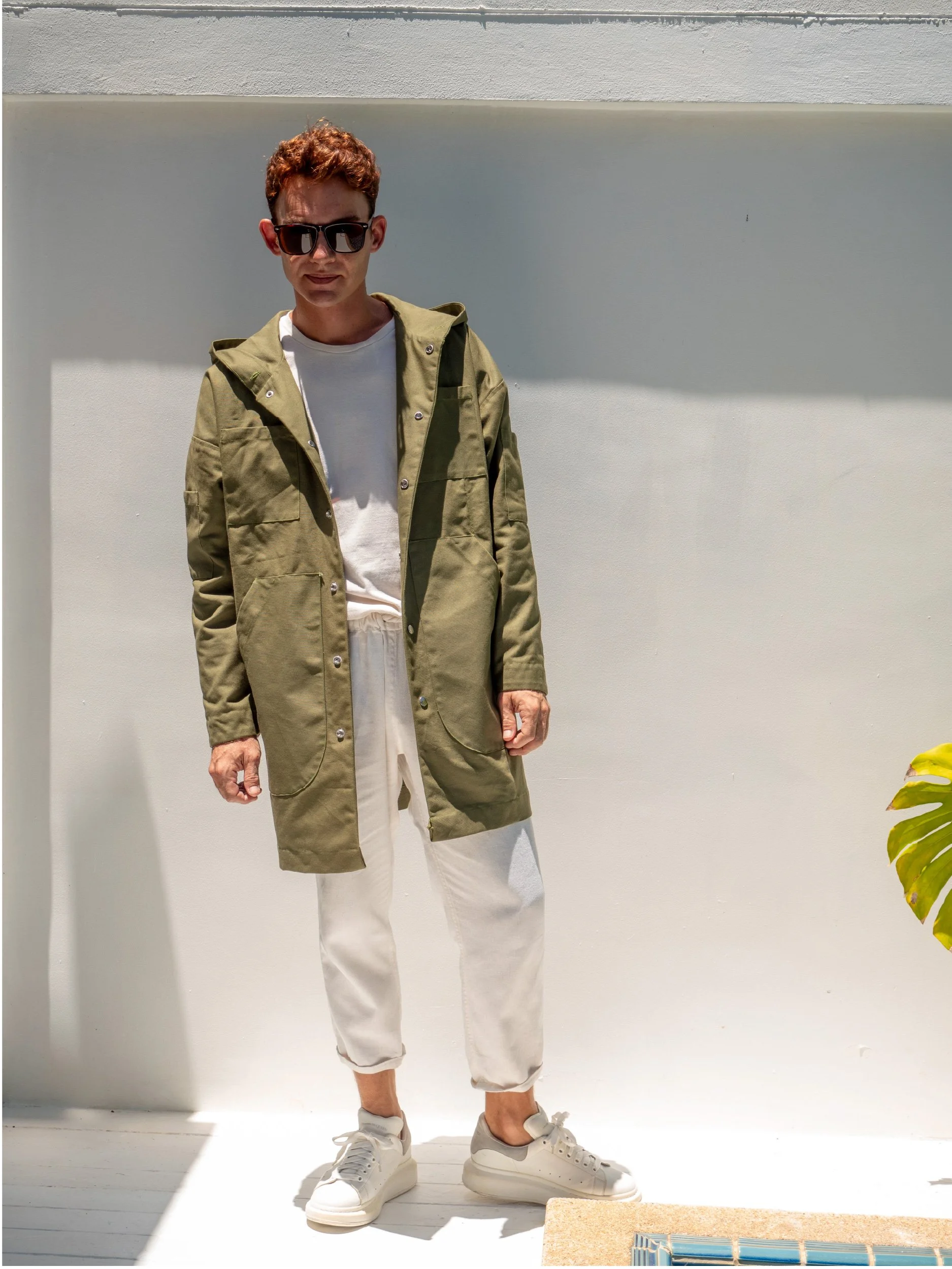 model wearing green boxy parka with hood