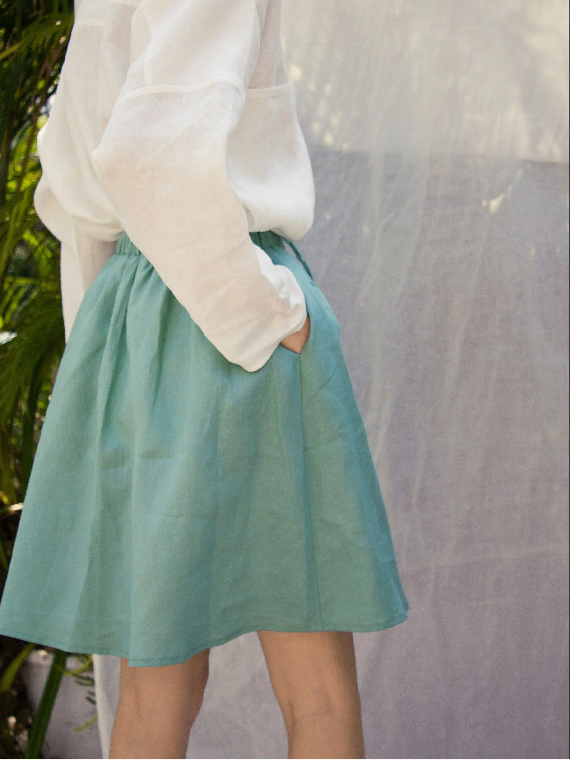 Lazy Skirt - model wearing skater length view with pockets in turquoise