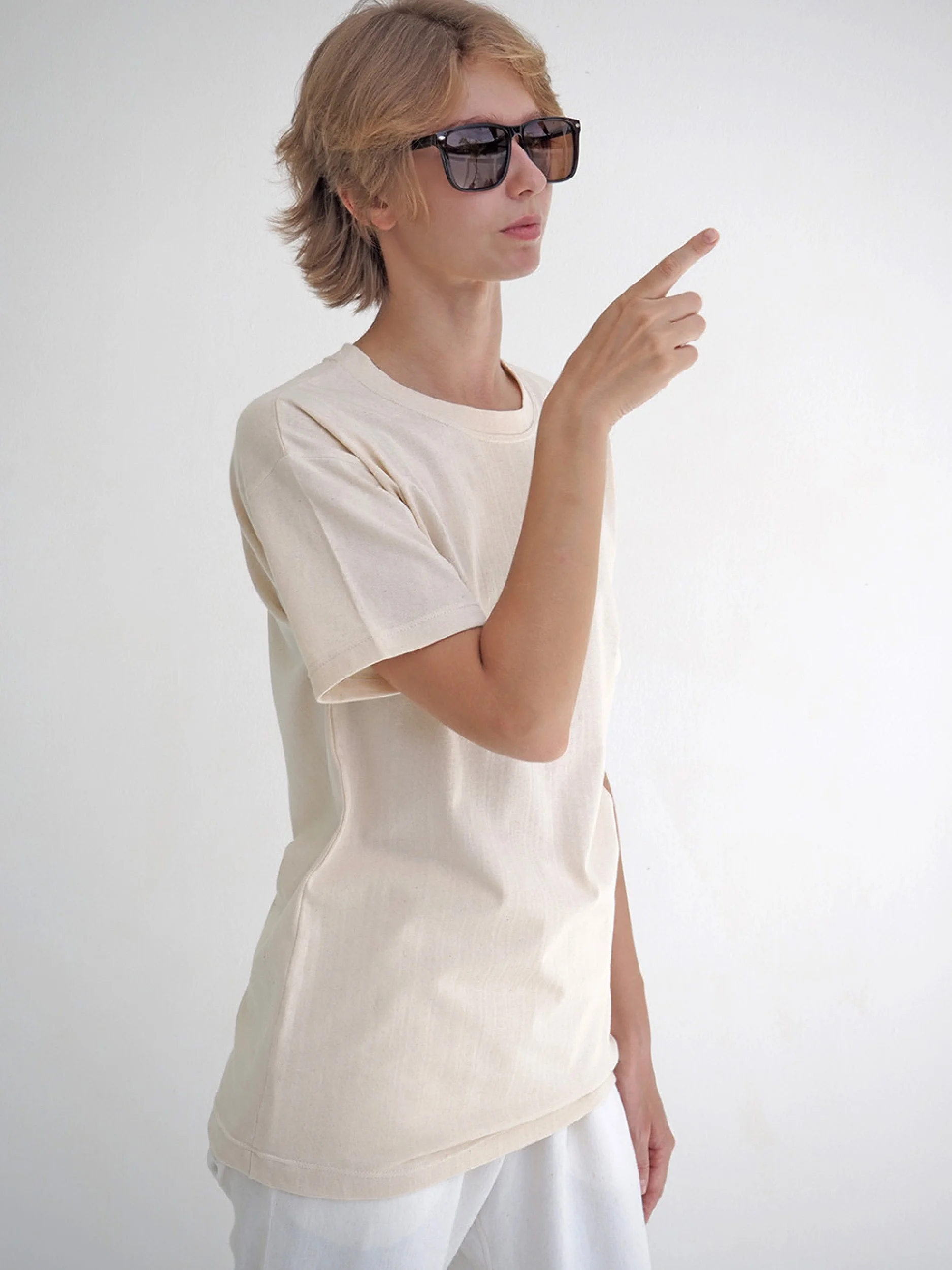 model wearing beige minimalist t-shirt with short sleeves