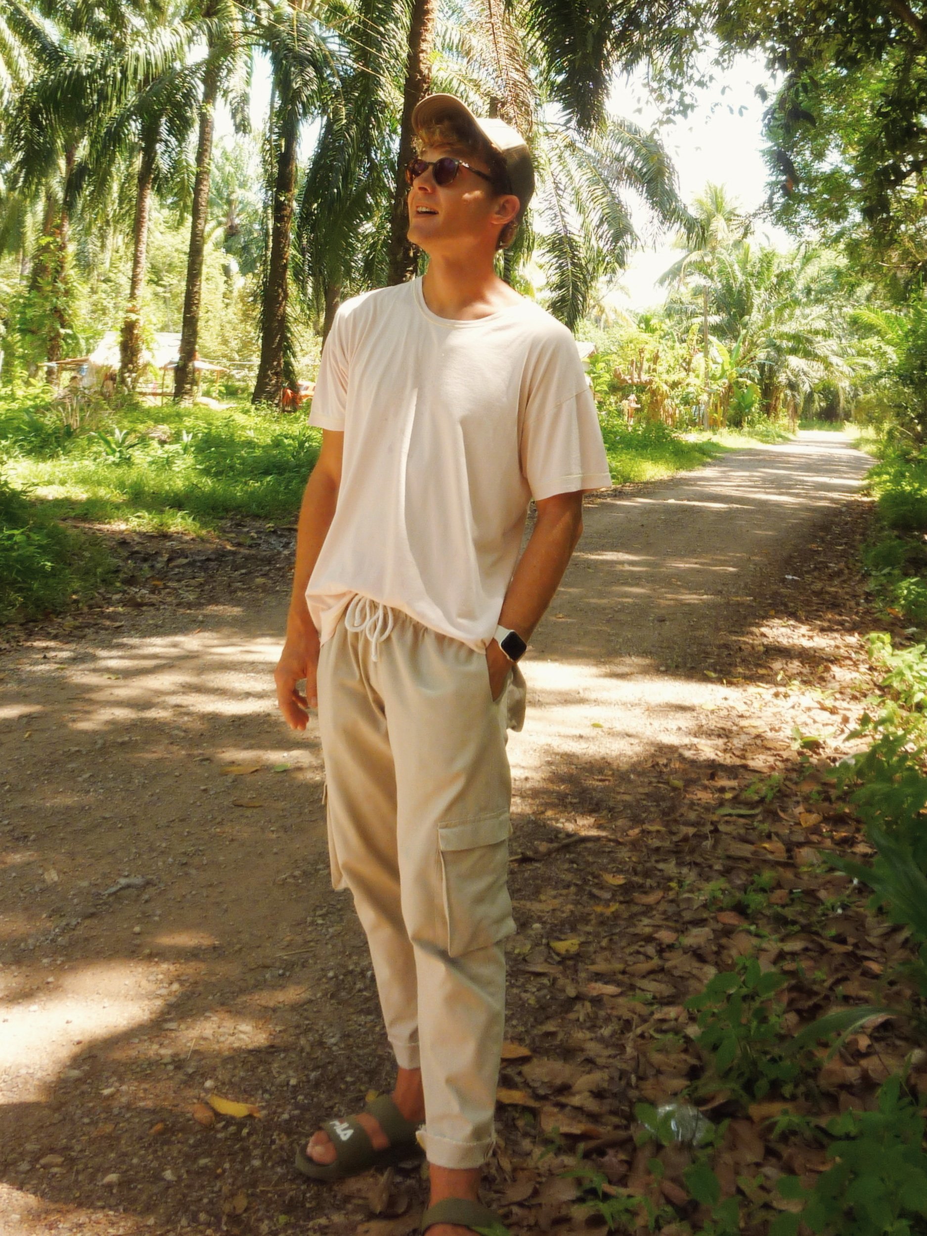model wearing tr lazy pants with cargo pockets on a sunny forest path
