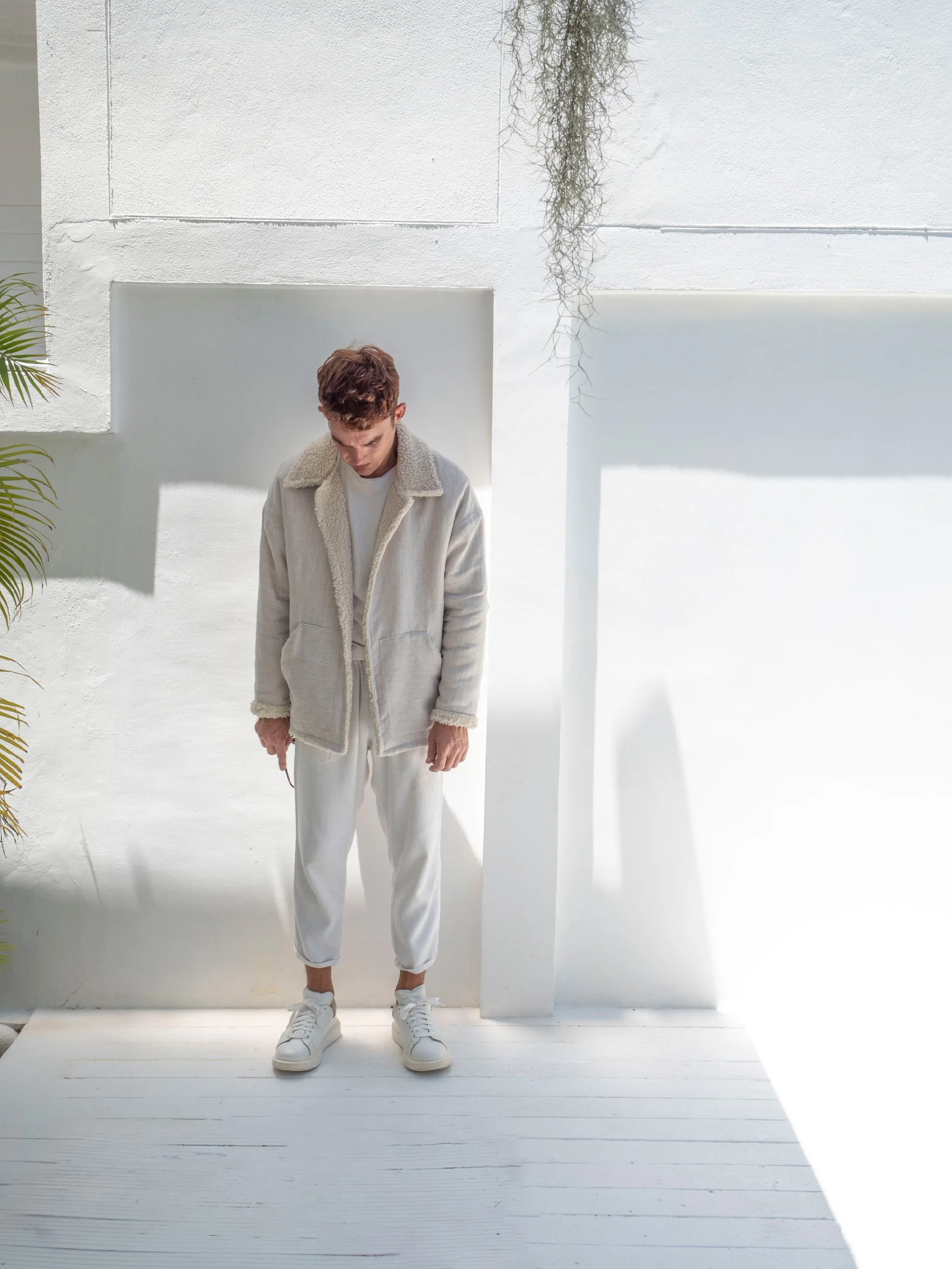 model wearing beige boxy parka sewn as a jacket with collar and sherpa lining