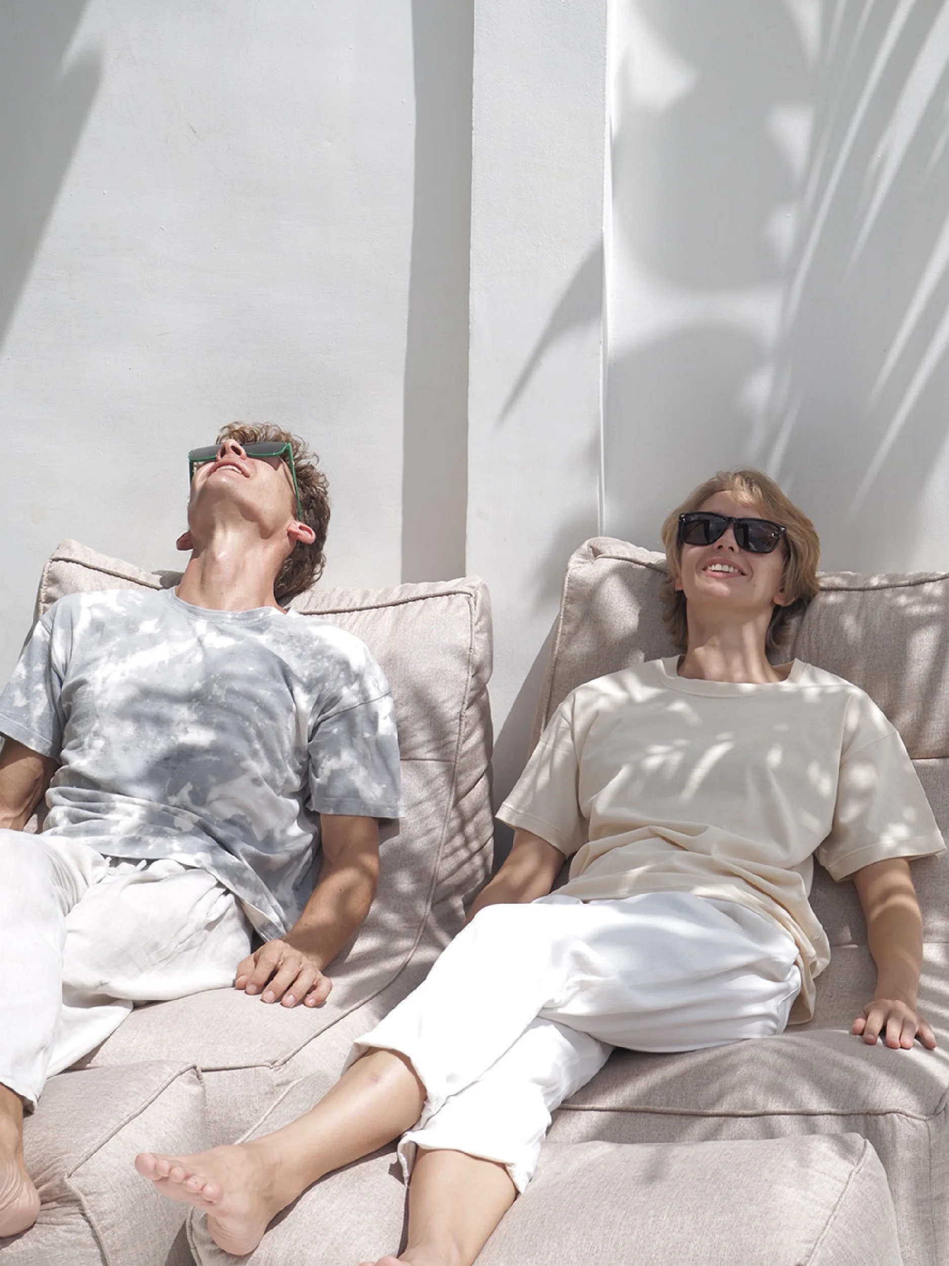 minimalist t-shirts  worn by models lounging on bean bags