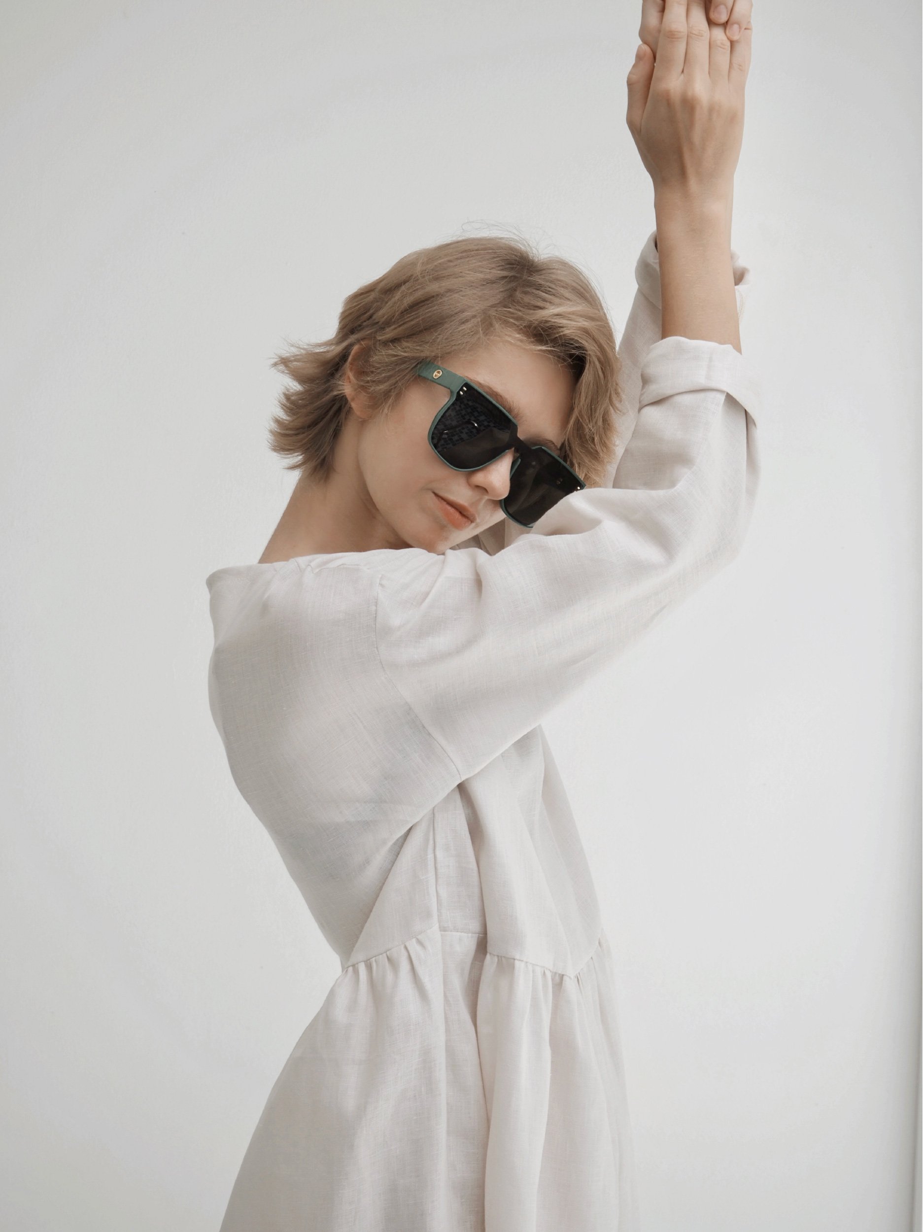 close up : model wearing lazy top waist crop with long sleeves and long gathered extension