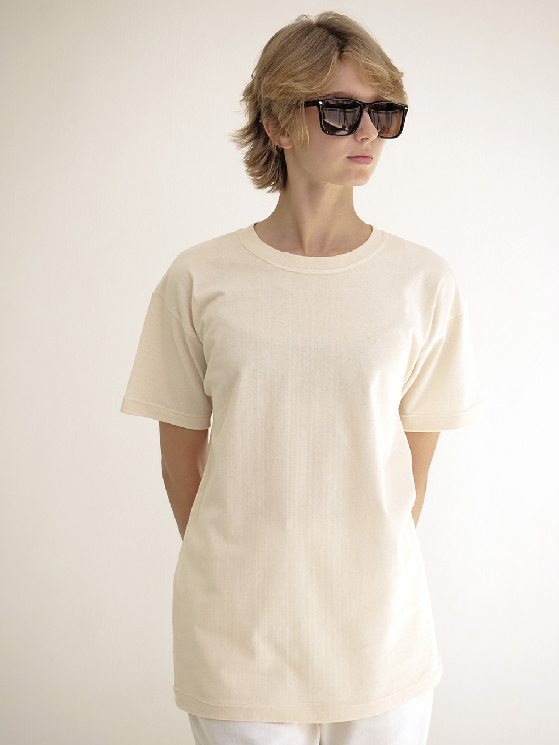 model wearing beige minimalist t-shirt with short sleeves